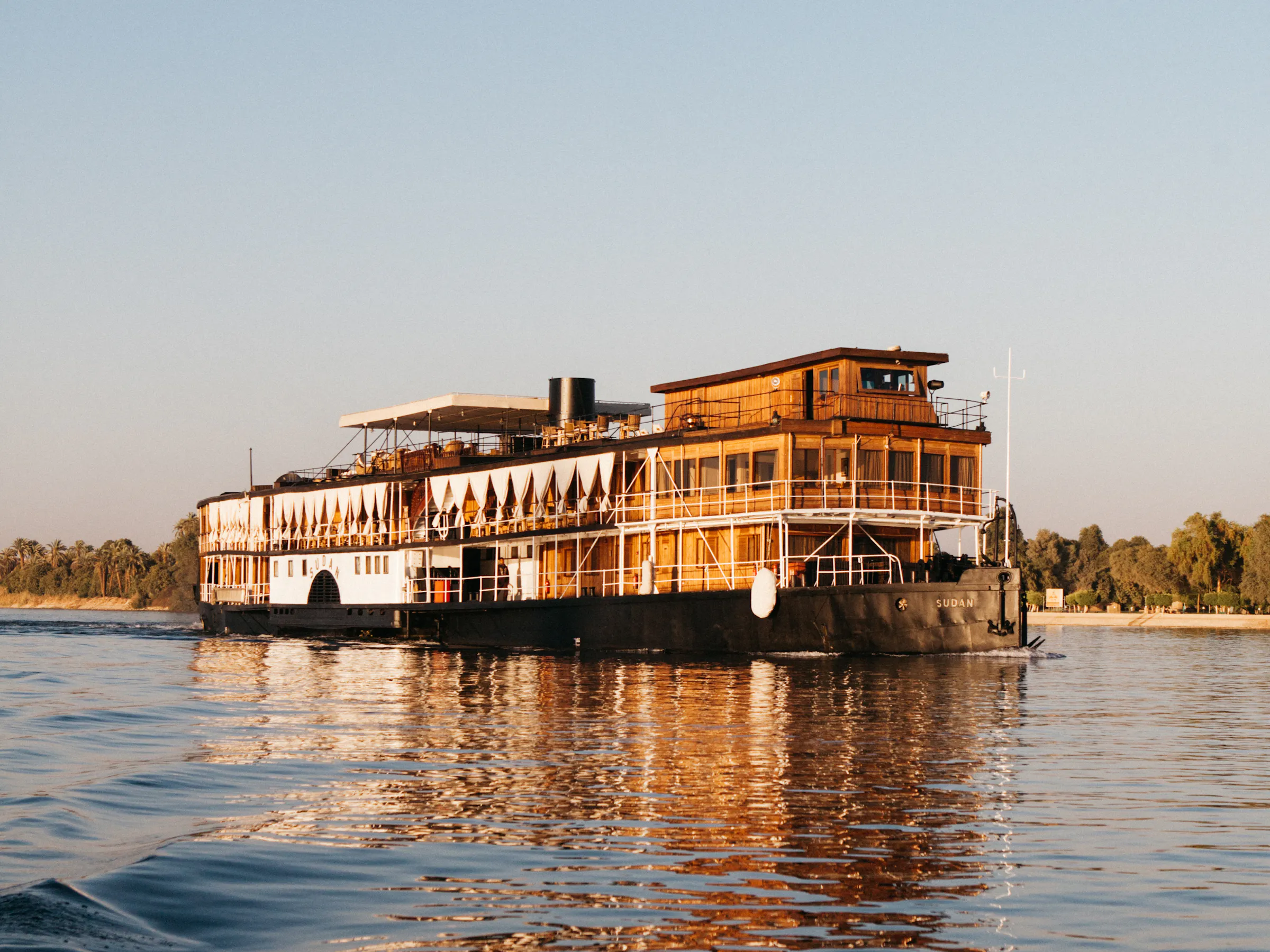 Historic SS Sudan steamboat cruising golden Nile River, Egypt