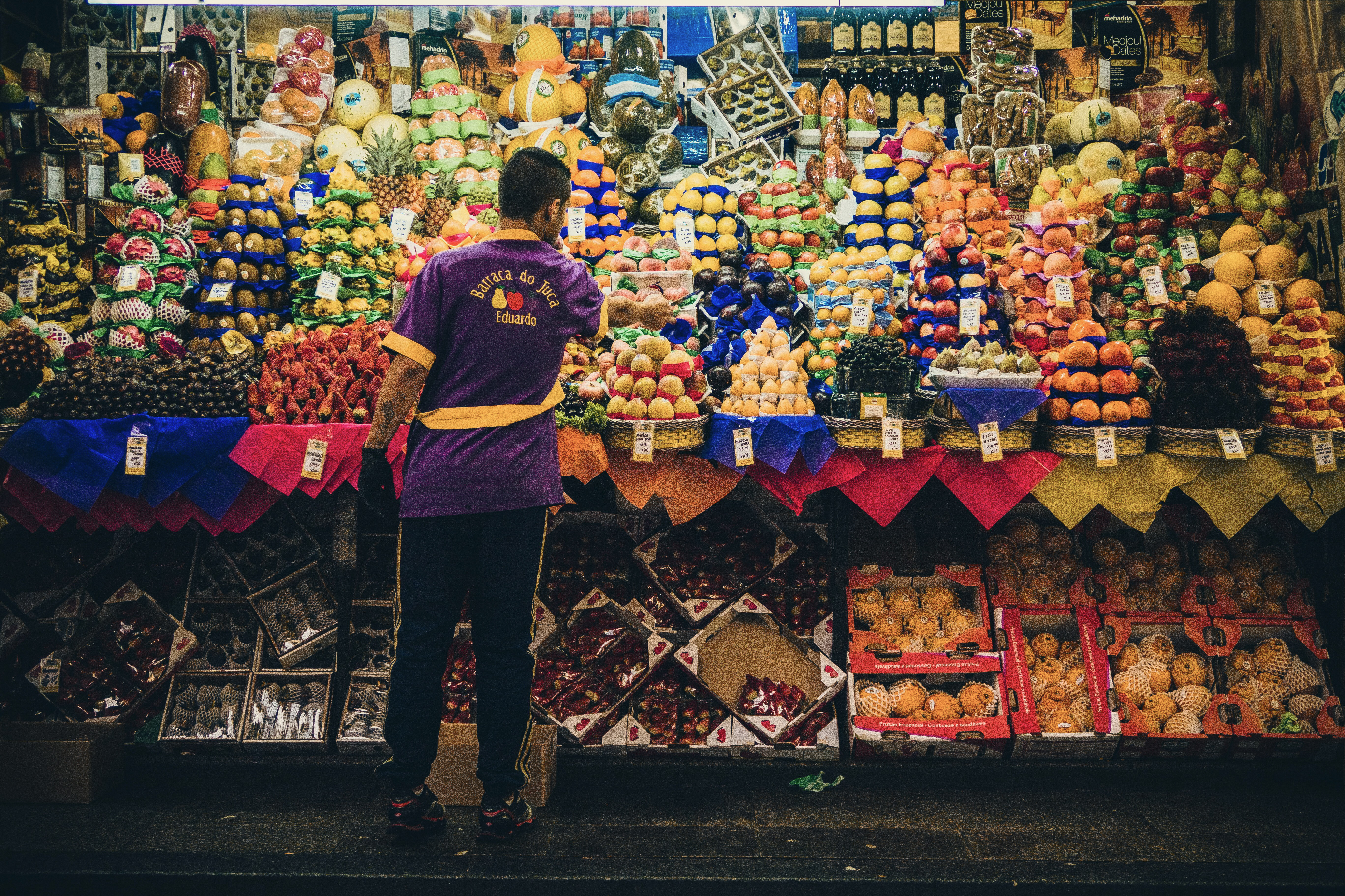 Colorful fruit vendor stall at Mercado Municipal, São Paulo Brazil