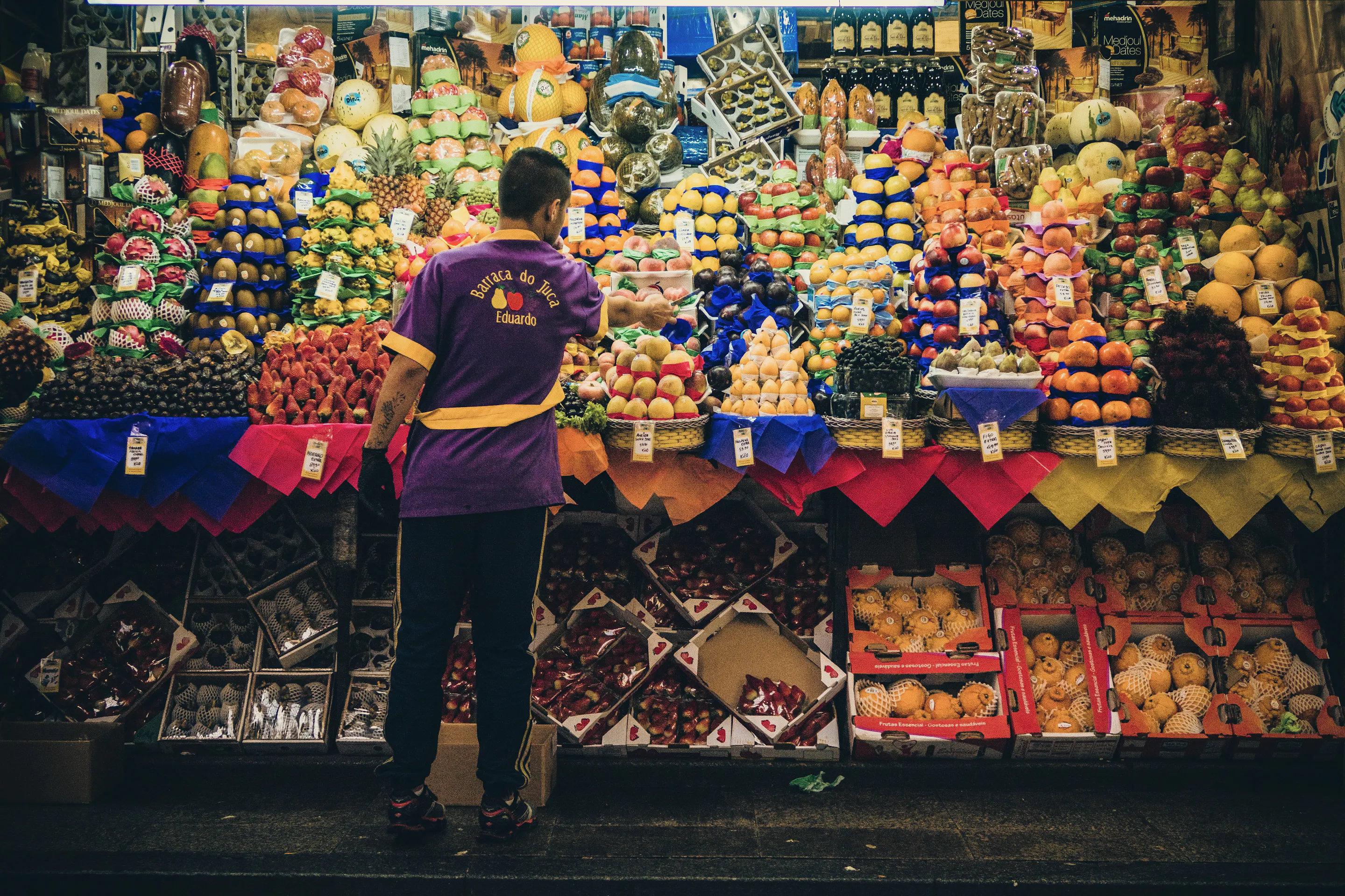 Colorful fruit vendor stall at Mercado Municipal, São Paulo Brazil