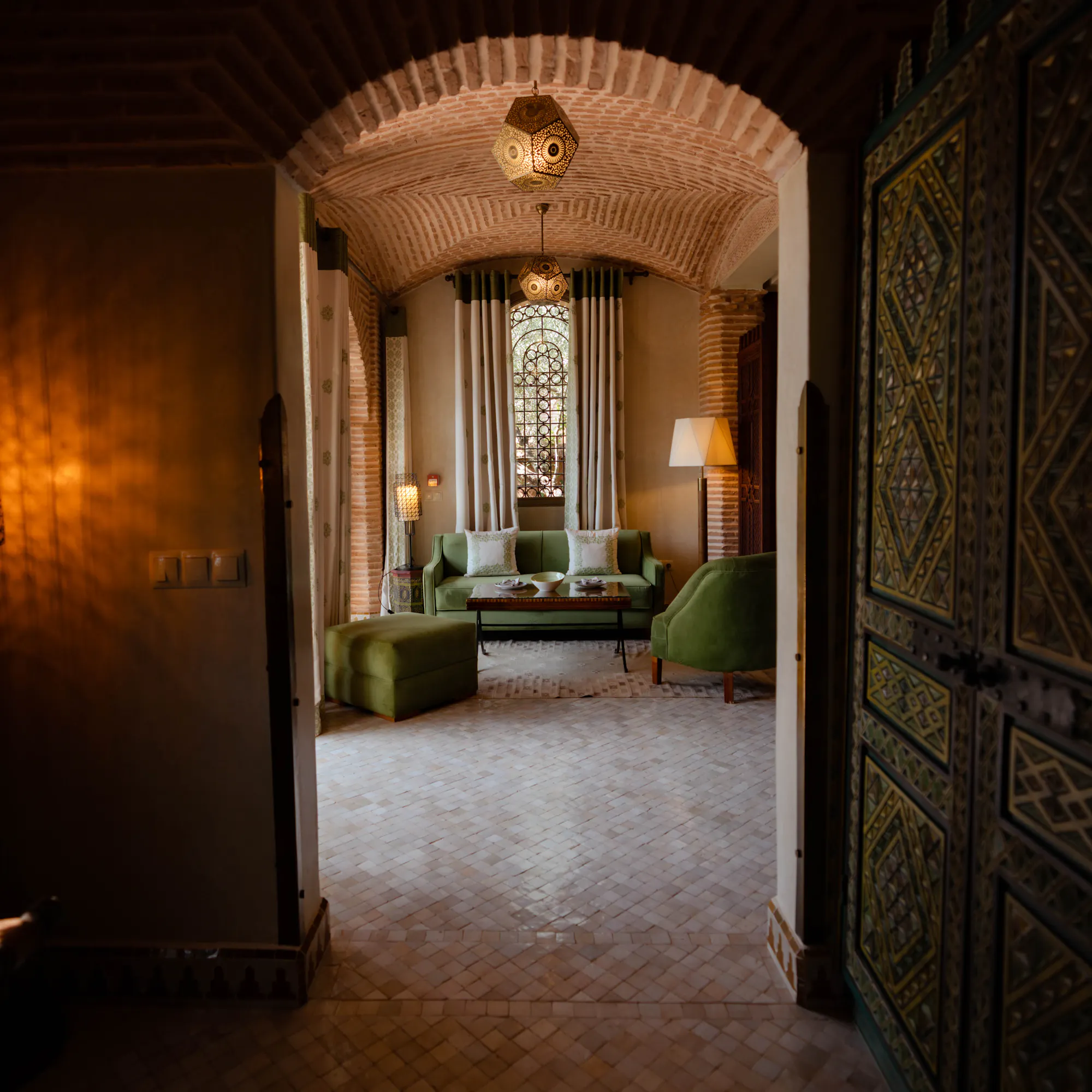 Ornate Moroccan riad interior with arched brick doorway, Morocco