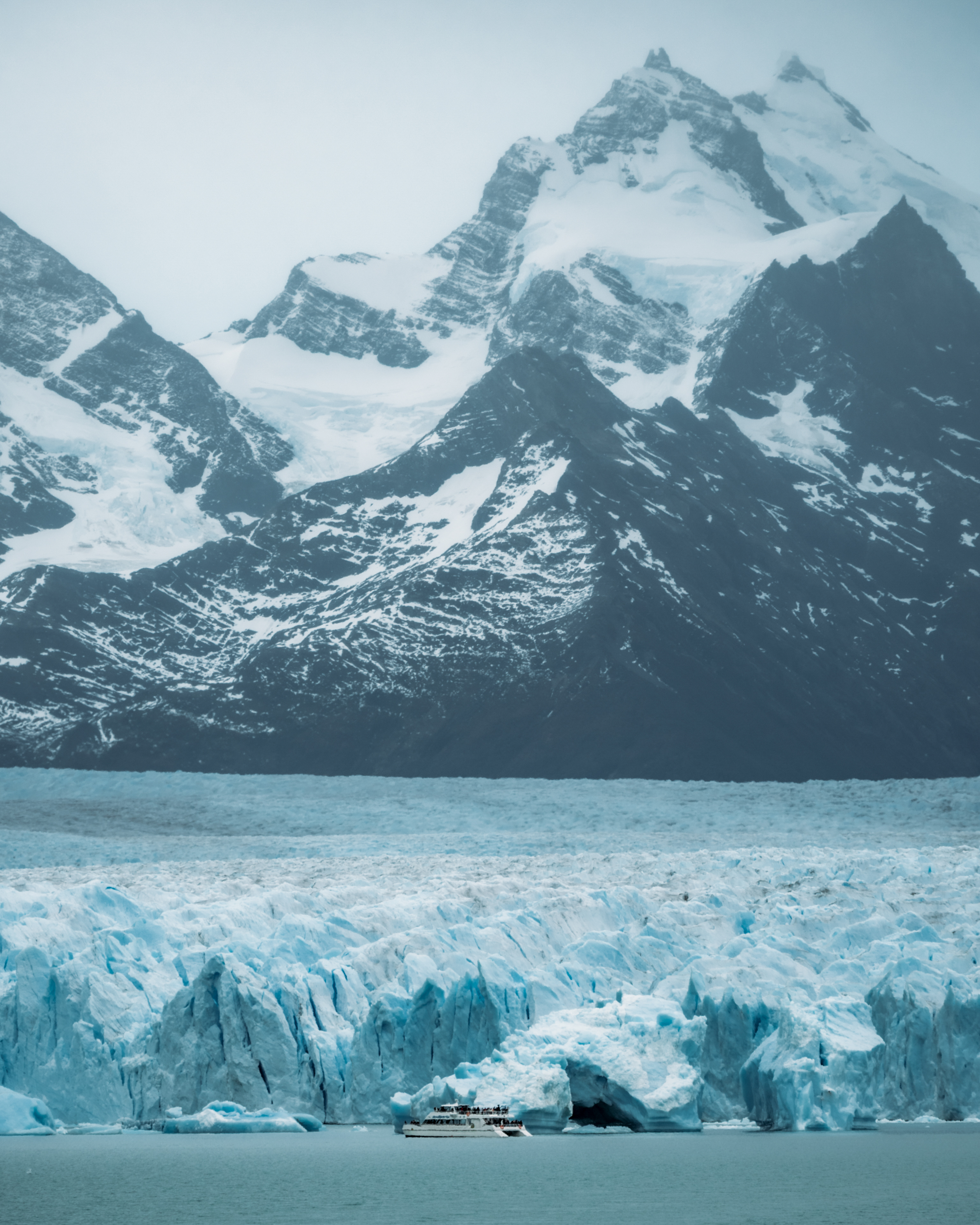 Tour boat beside Perito Moreno Glacier ice face, Argentine Patagonia