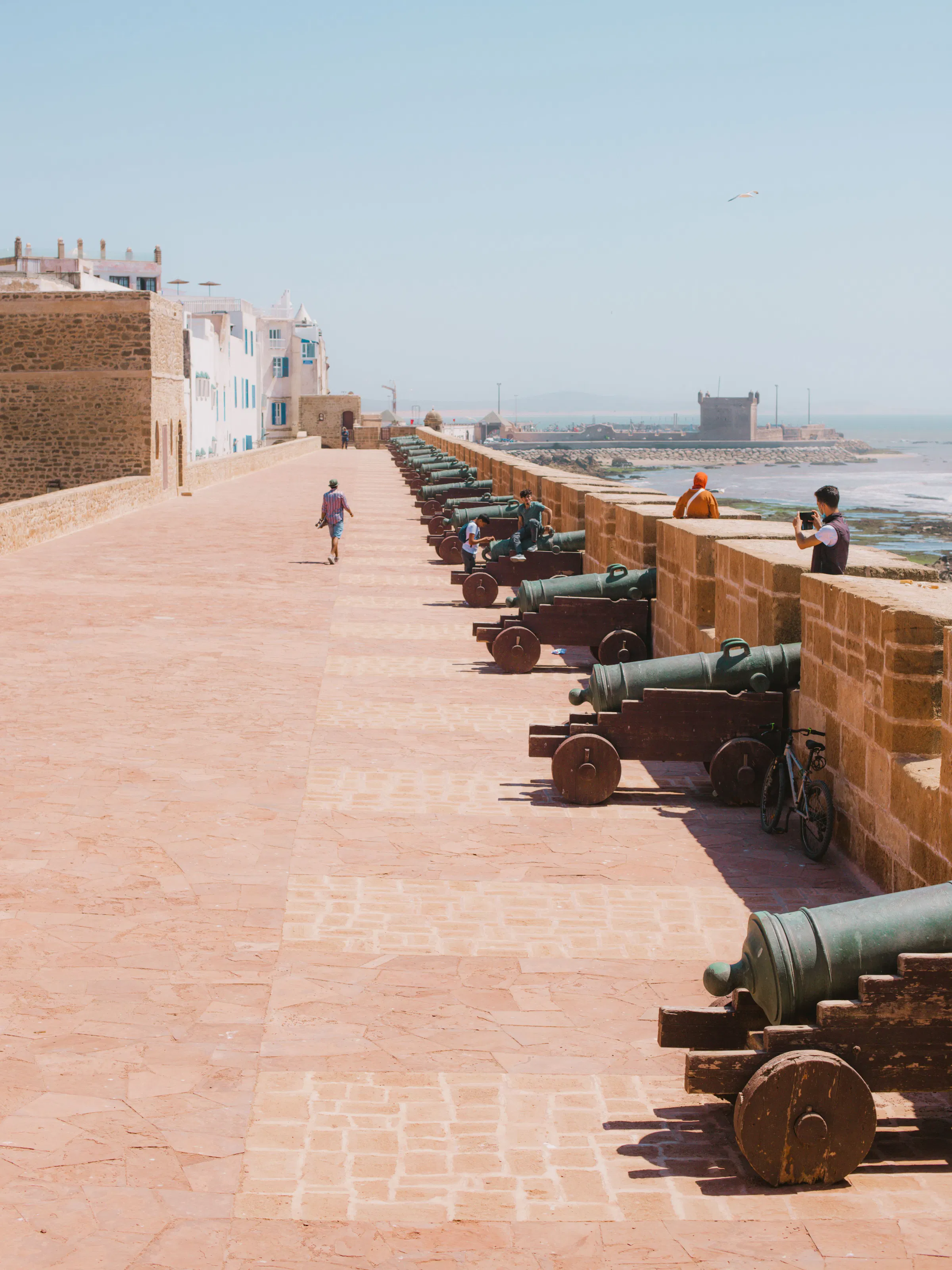 Historic cannons lining the Skala de la Ville ramparts overlooking the sea in Essaouira, Morocco
