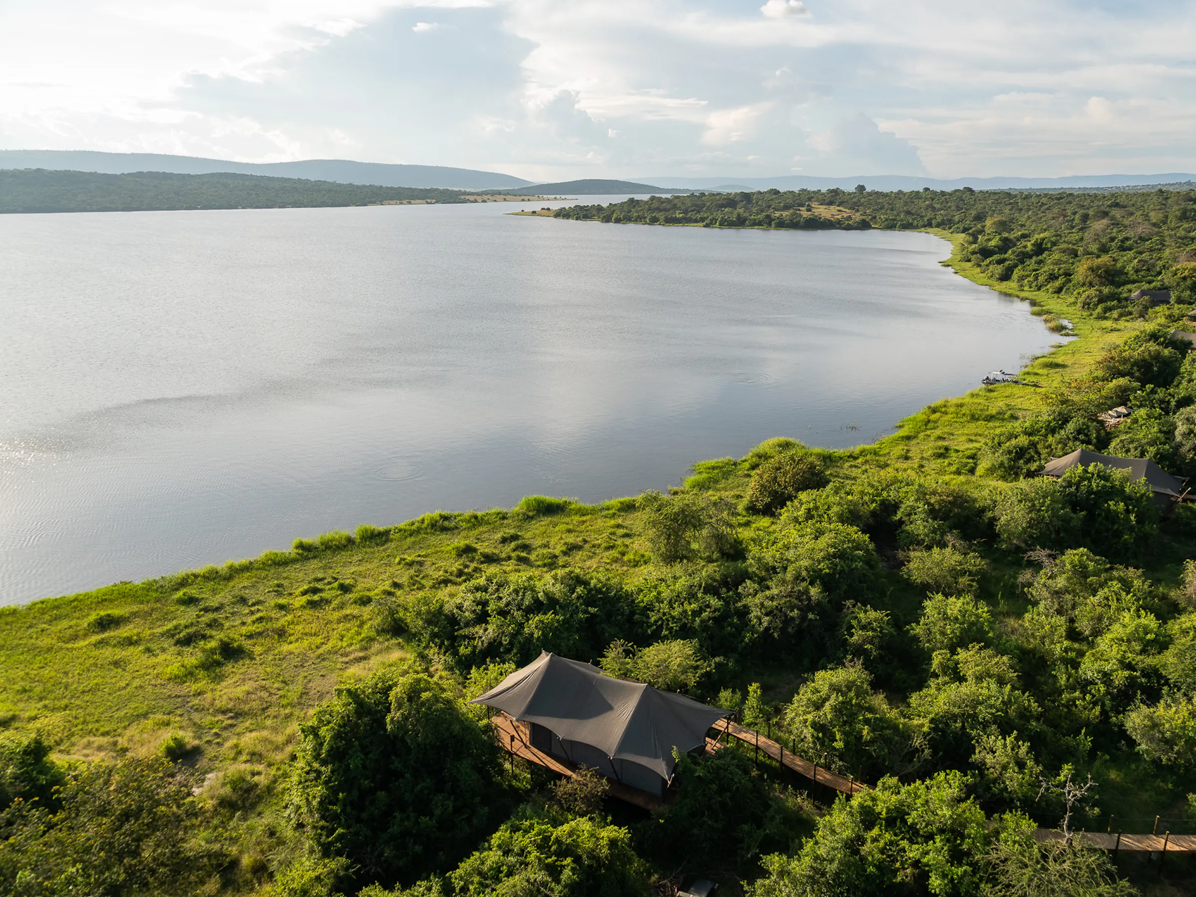 Aerial view of Magashi Camp tents along the lakeshore in Akagera National Park, Rwanda
