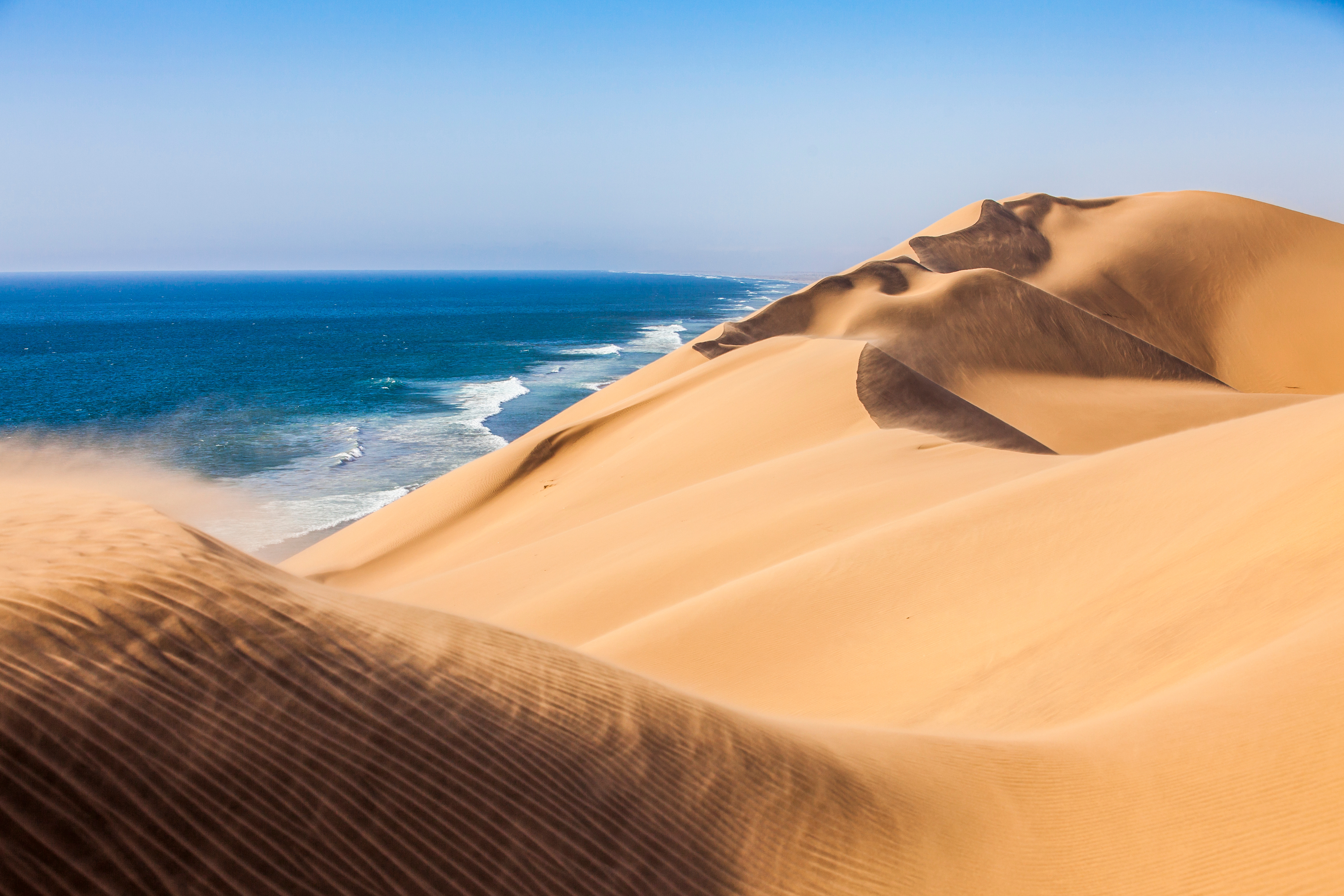 Namib Desert sand dunes meeting Atlantic Ocean, Sandwich Harbour Namibia