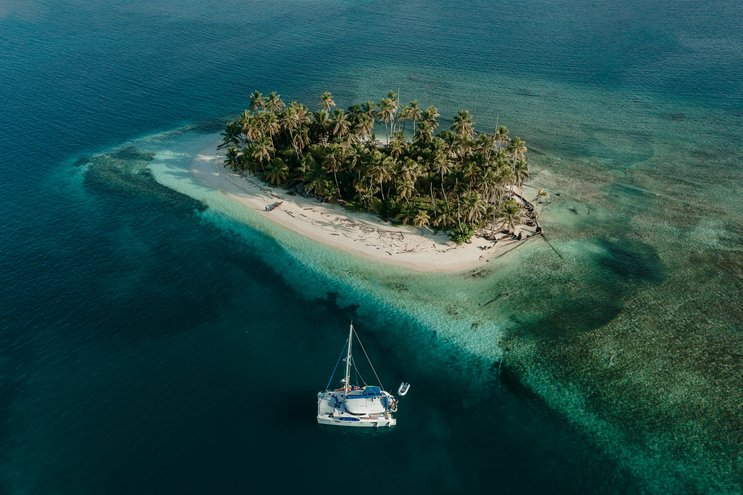 boat on reef and tropical island