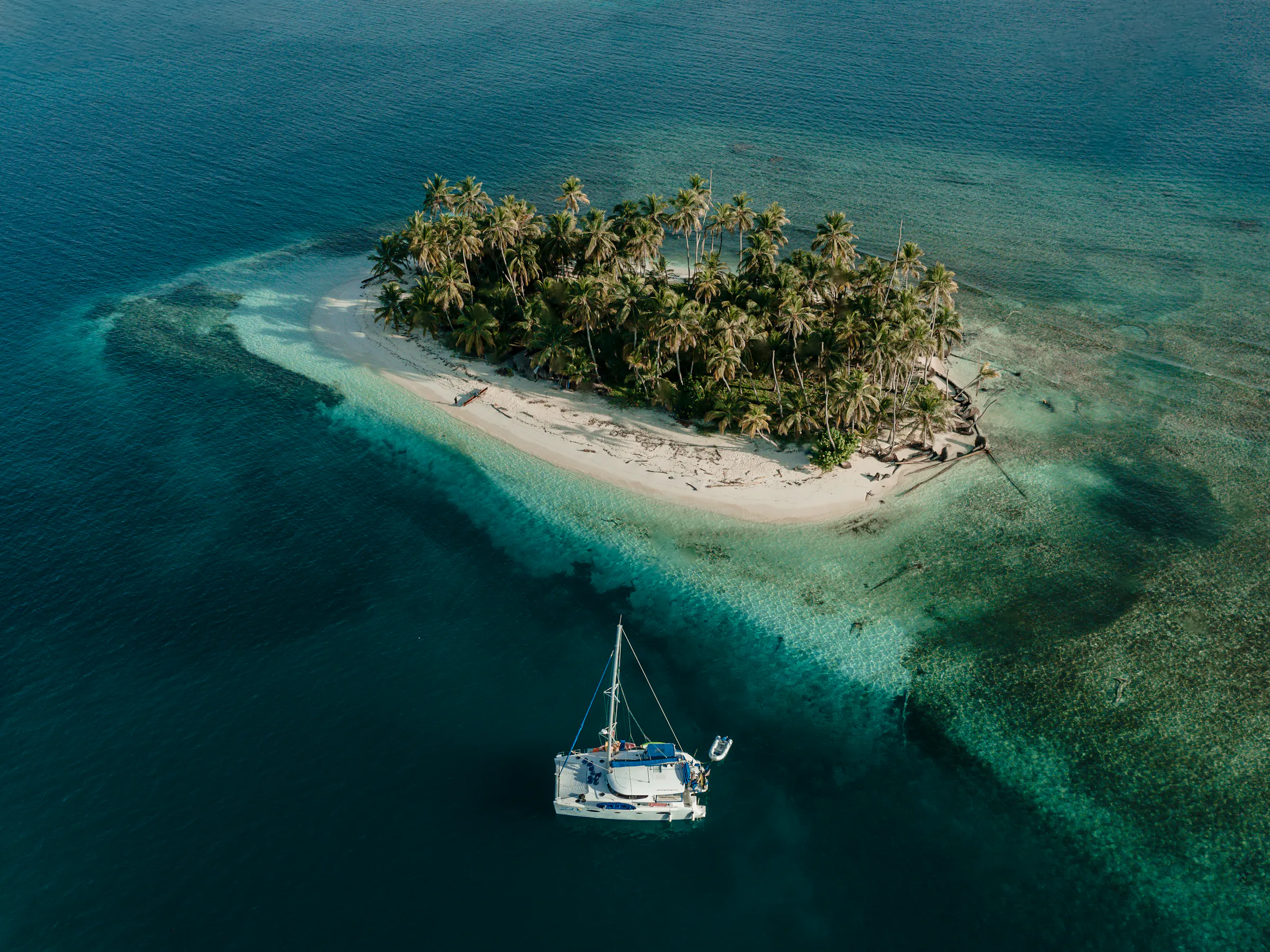 boat on reef and tropical island
