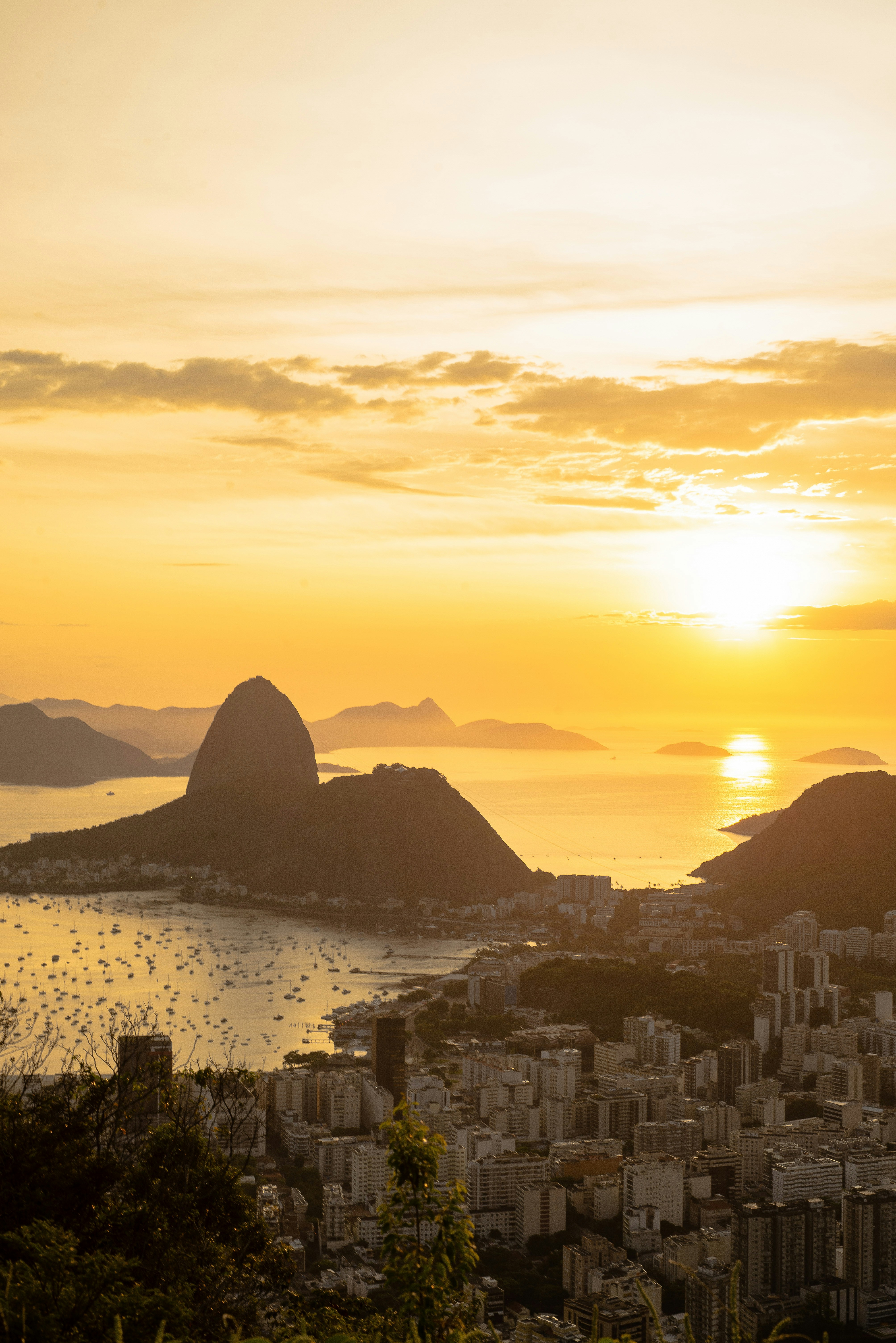 Golden sunset silhouetting Sugarloaf Mountain over Guanabara Bay, Rio de Janeiro
