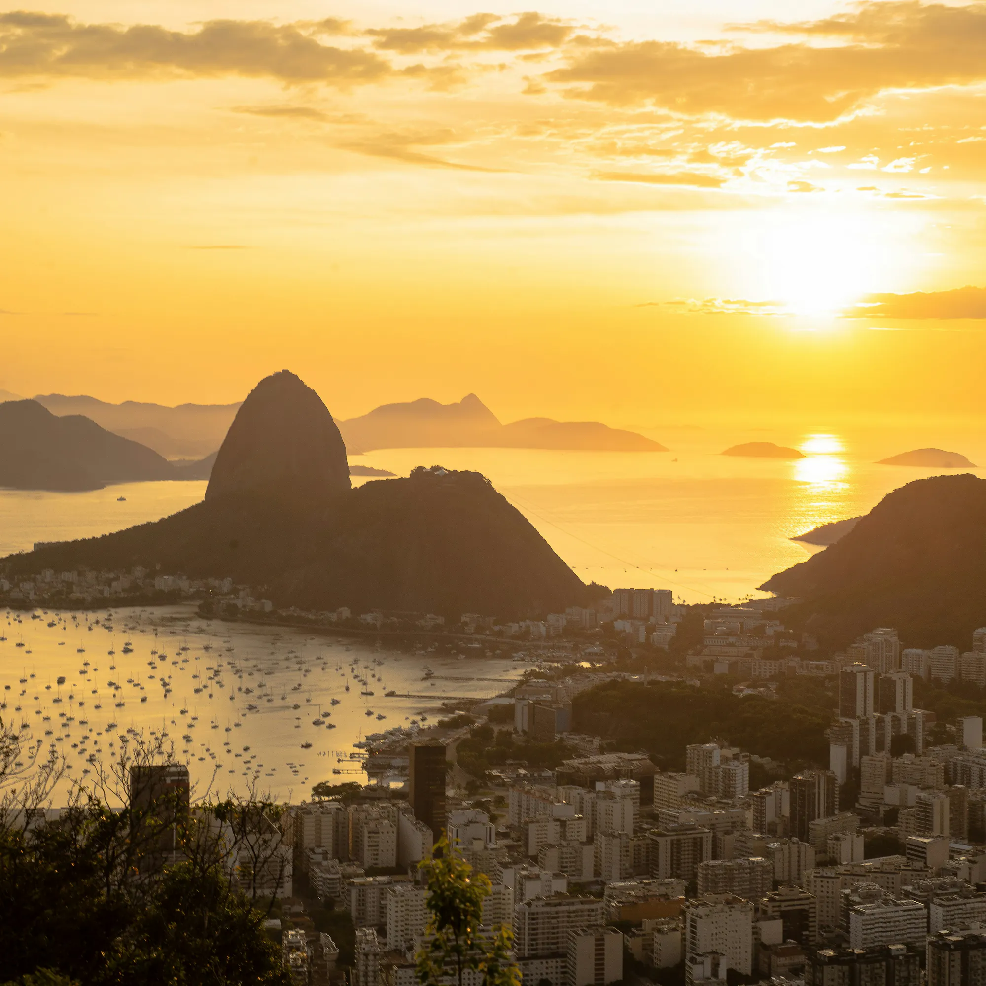 Golden sunset silhouetting Sugarloaf Mountain over Guanabara Bay, Rio de Janeiro