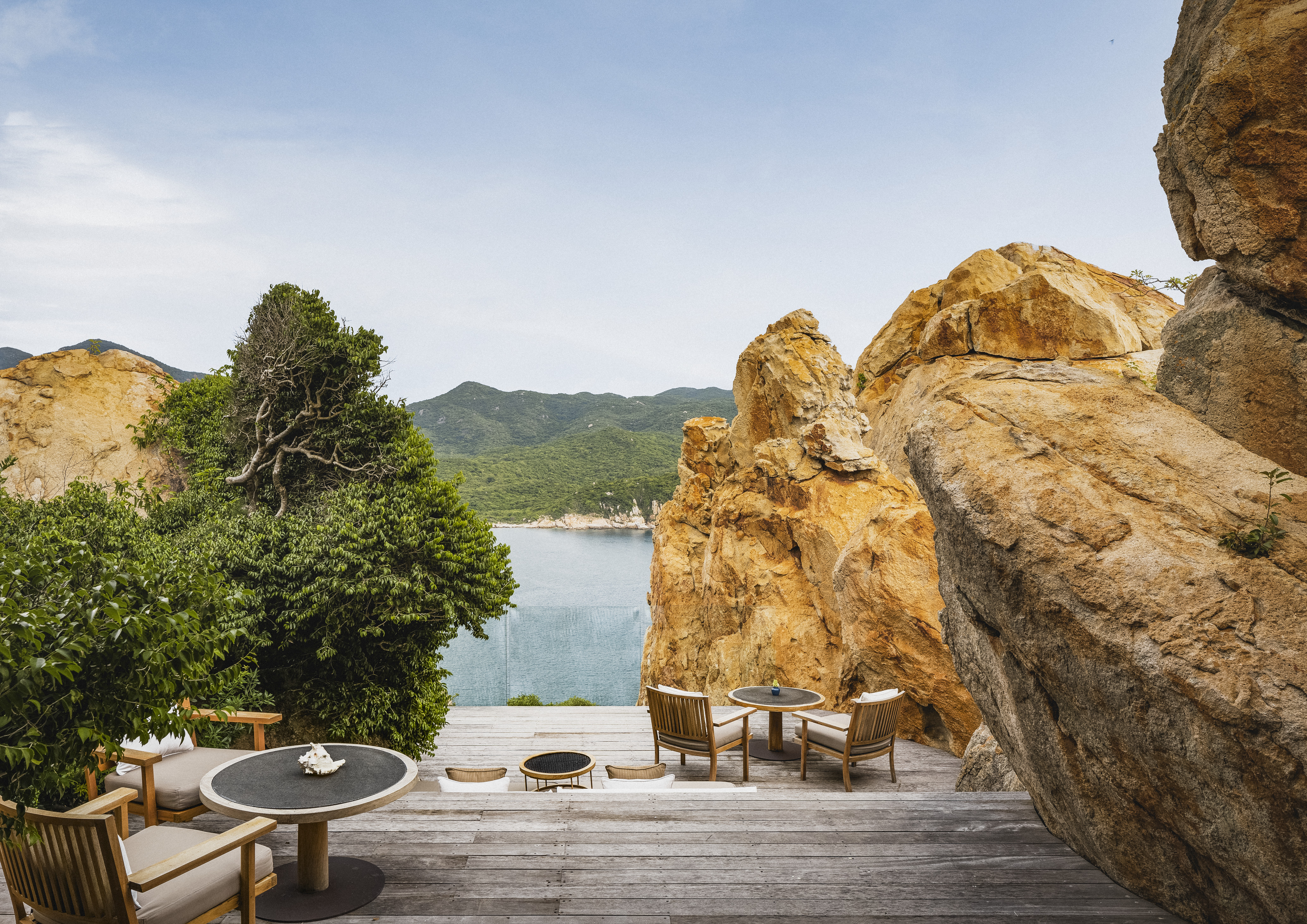Luxury resort terrace between granite boulders overlooking bay, Con Dao Vietnam