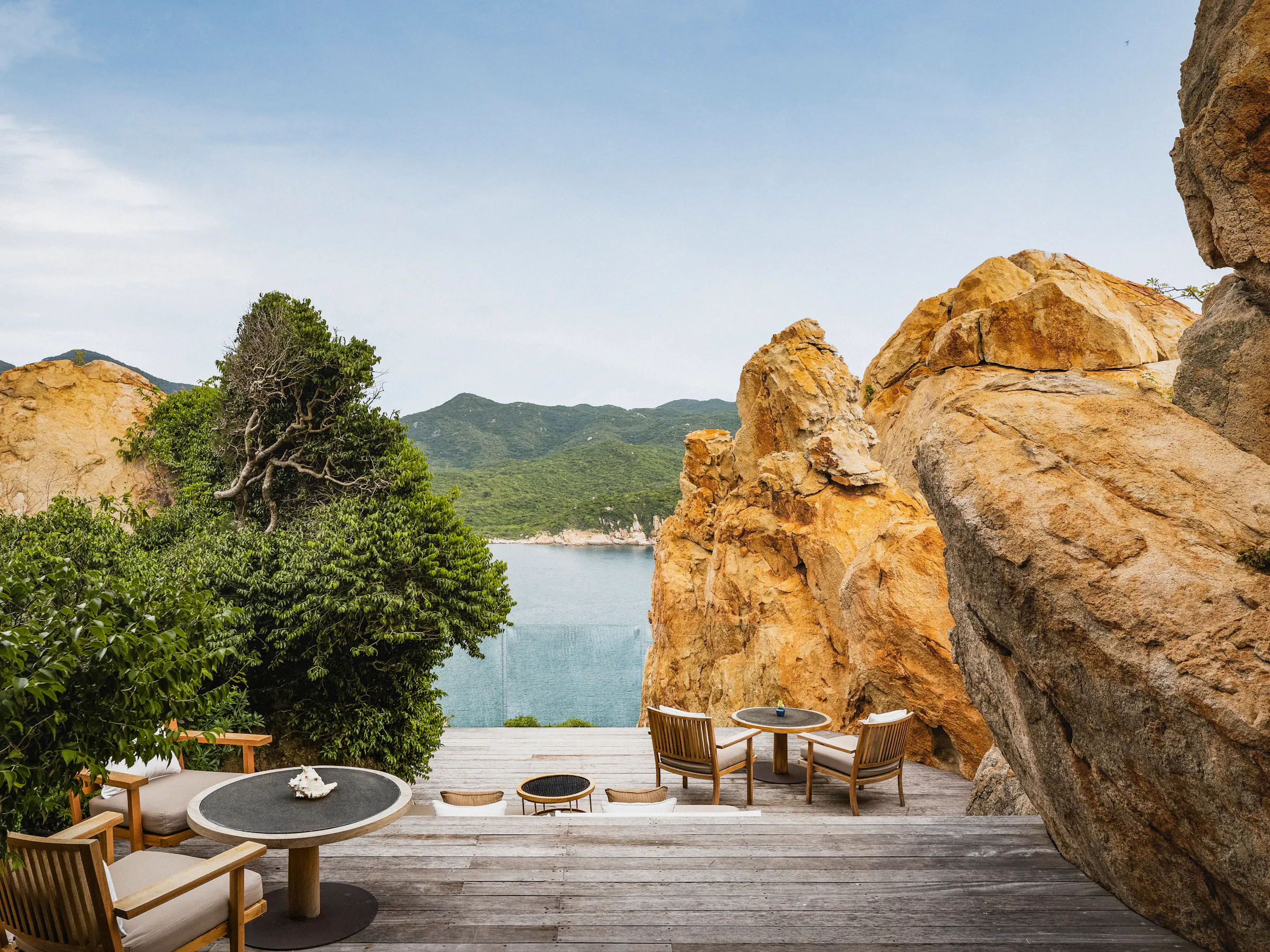 Luxury resort terrace between granite boulders overlooking bay, Con Dao Vietnam