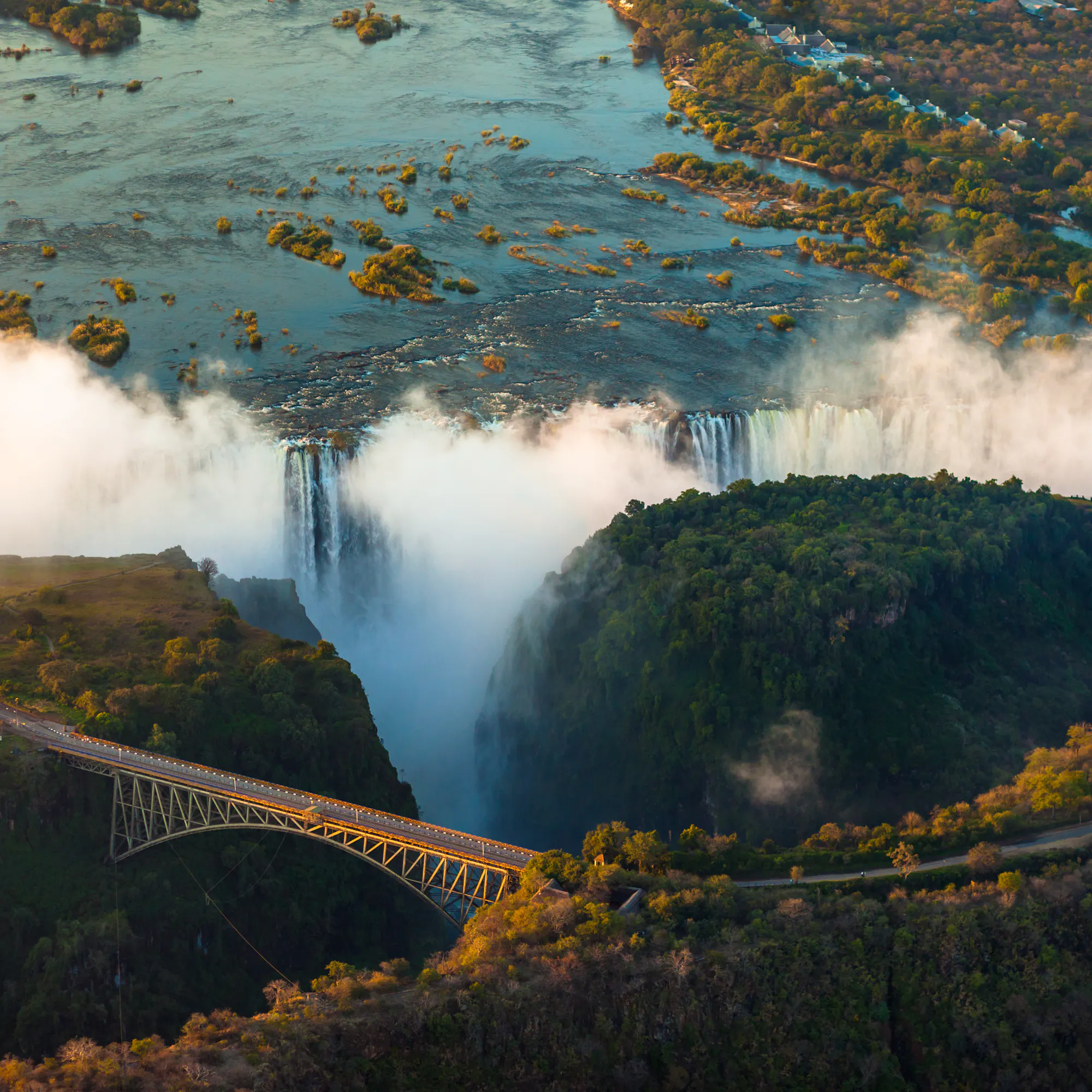 Aerial view Victoria Falls and historic bridge, Zimbabwe Zambia border