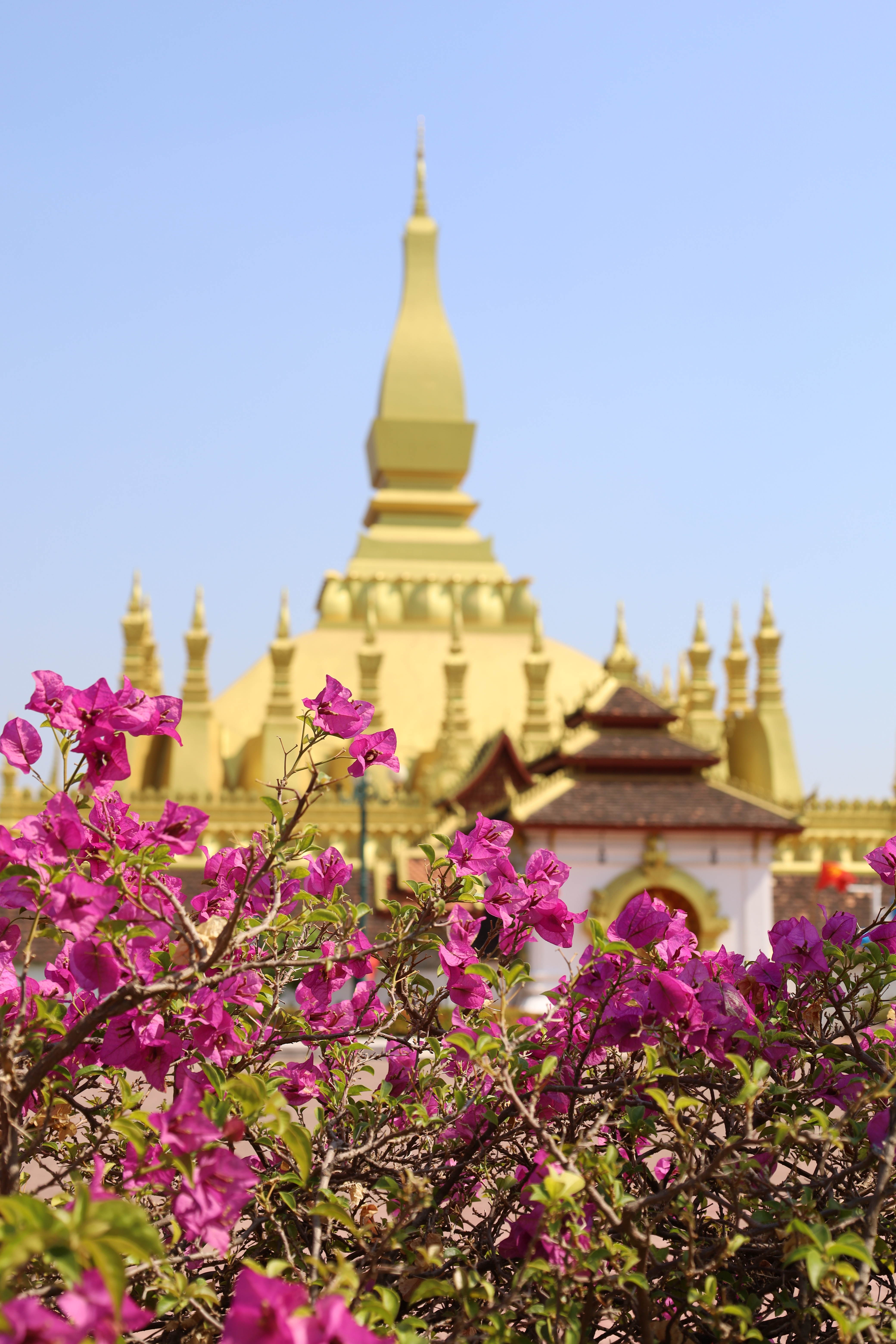 Golden Buddha statue in a pavilion at a Vientiane temple, Laos
