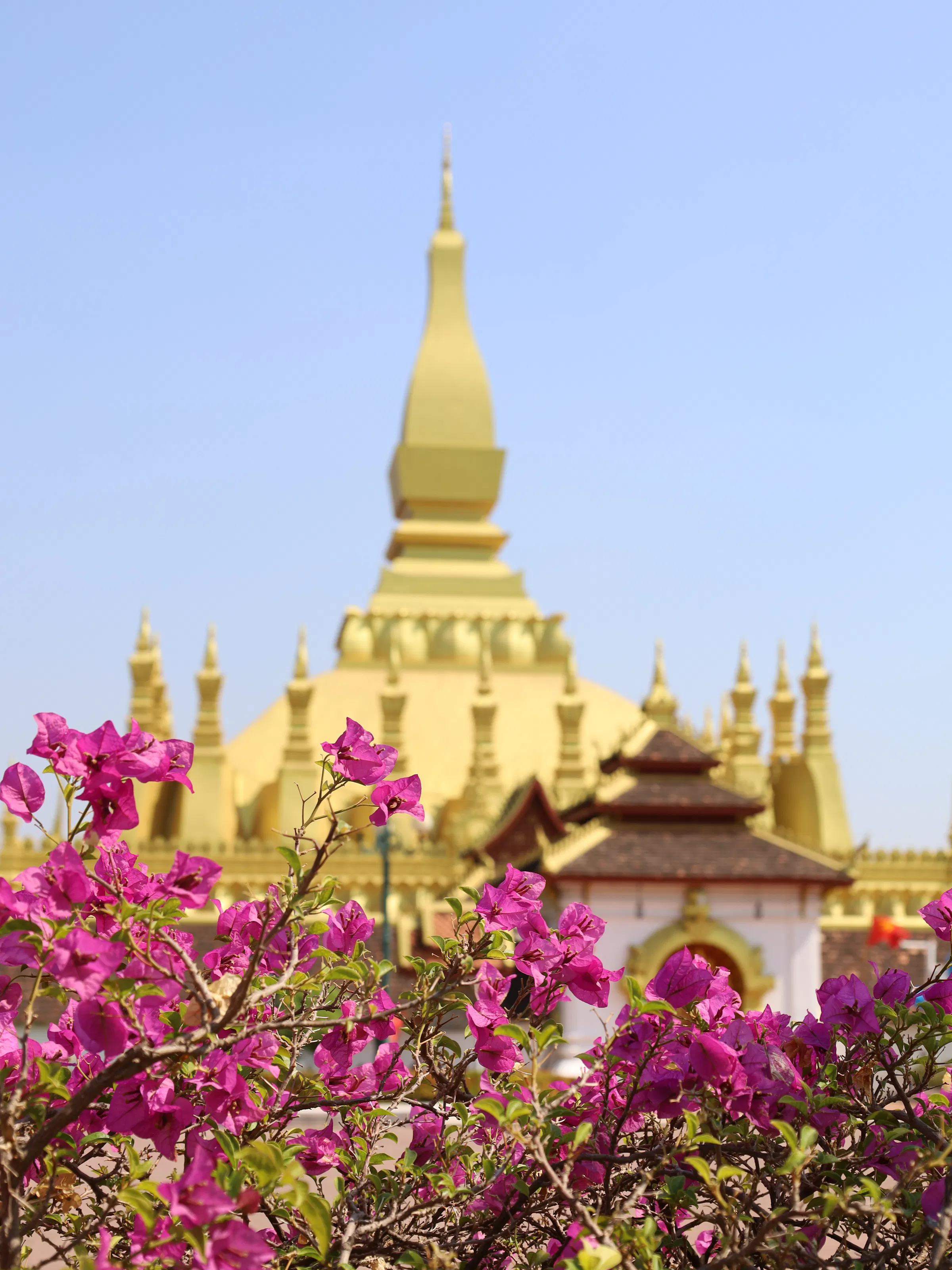 Golden Buddha statue in a pavilion at a Vientiane temple, Laos