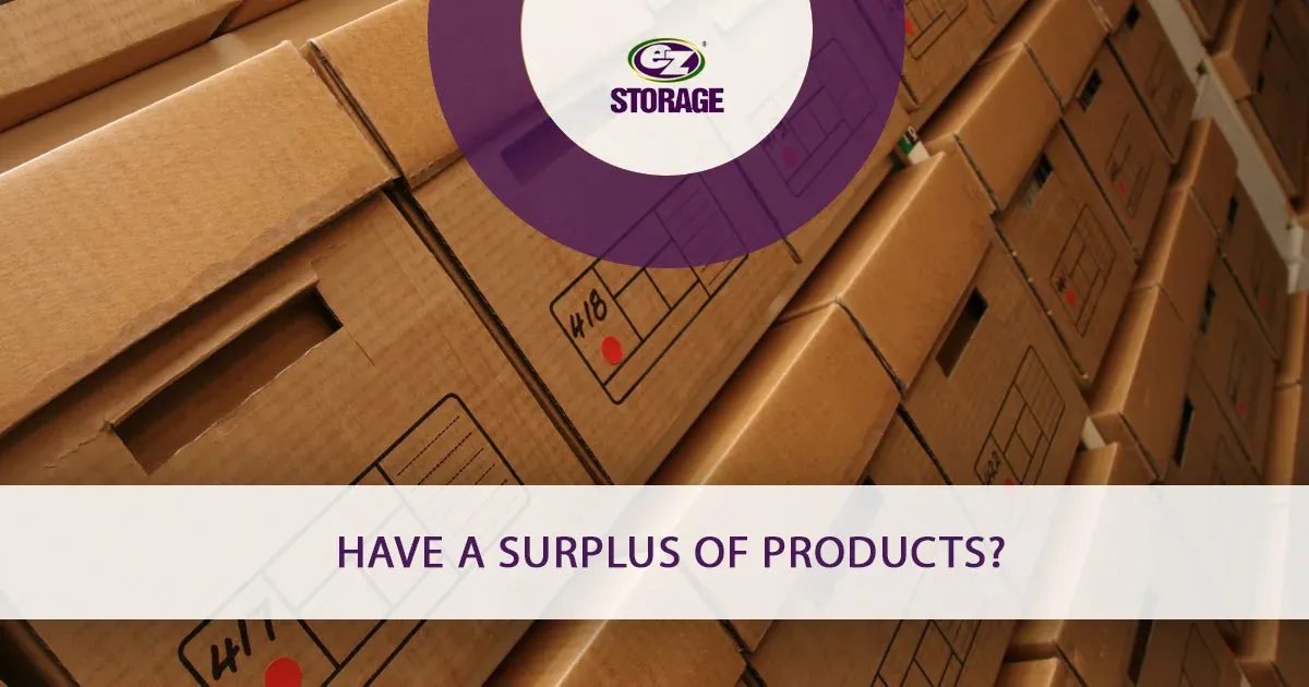 Several boxes with lids stacked perfectly together and text "have a surplus of products"