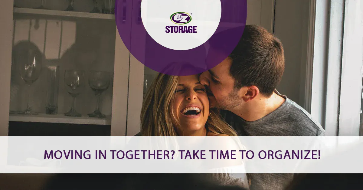 Man kissing his female partner and text "Moving in together? Take time to organize"