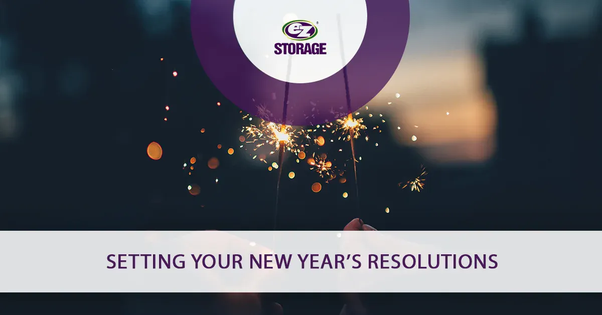 Hands holding up a lit sparkler and text "Setting your New Year's resolutions"