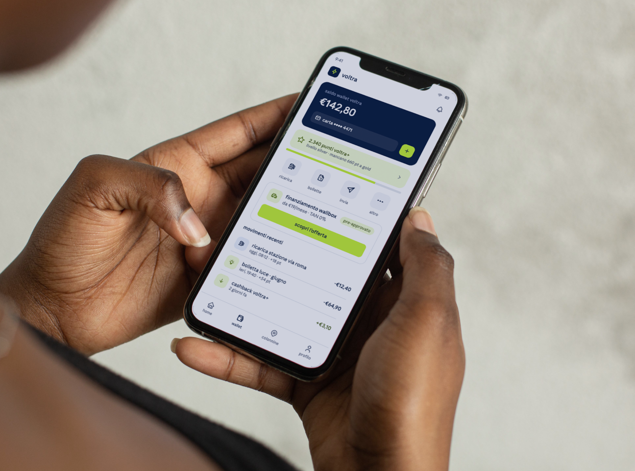 Persona utilizza sullo smartphone un wallet digitale con saldo, pagamenti, cashback e punti fedeltà.