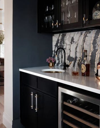 black cabinets paired with an elegant backsplash 