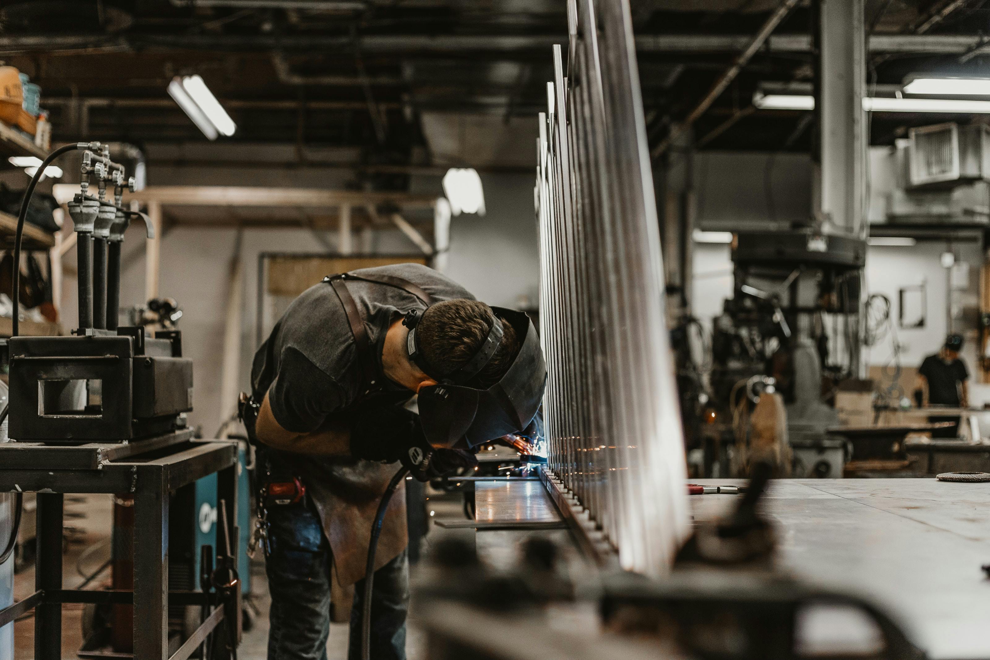 Person welding in workshop