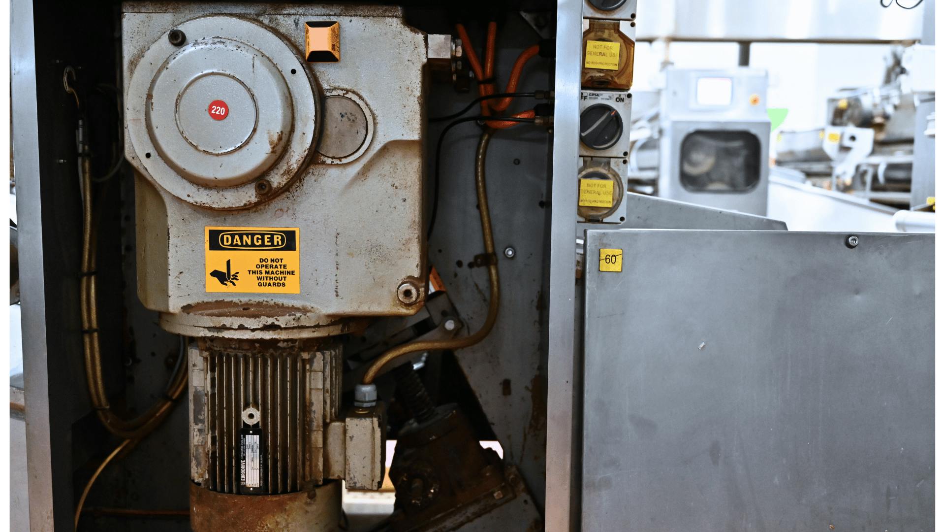 Industrial motor and gearbox with wireless vibration and temperature sensor installed