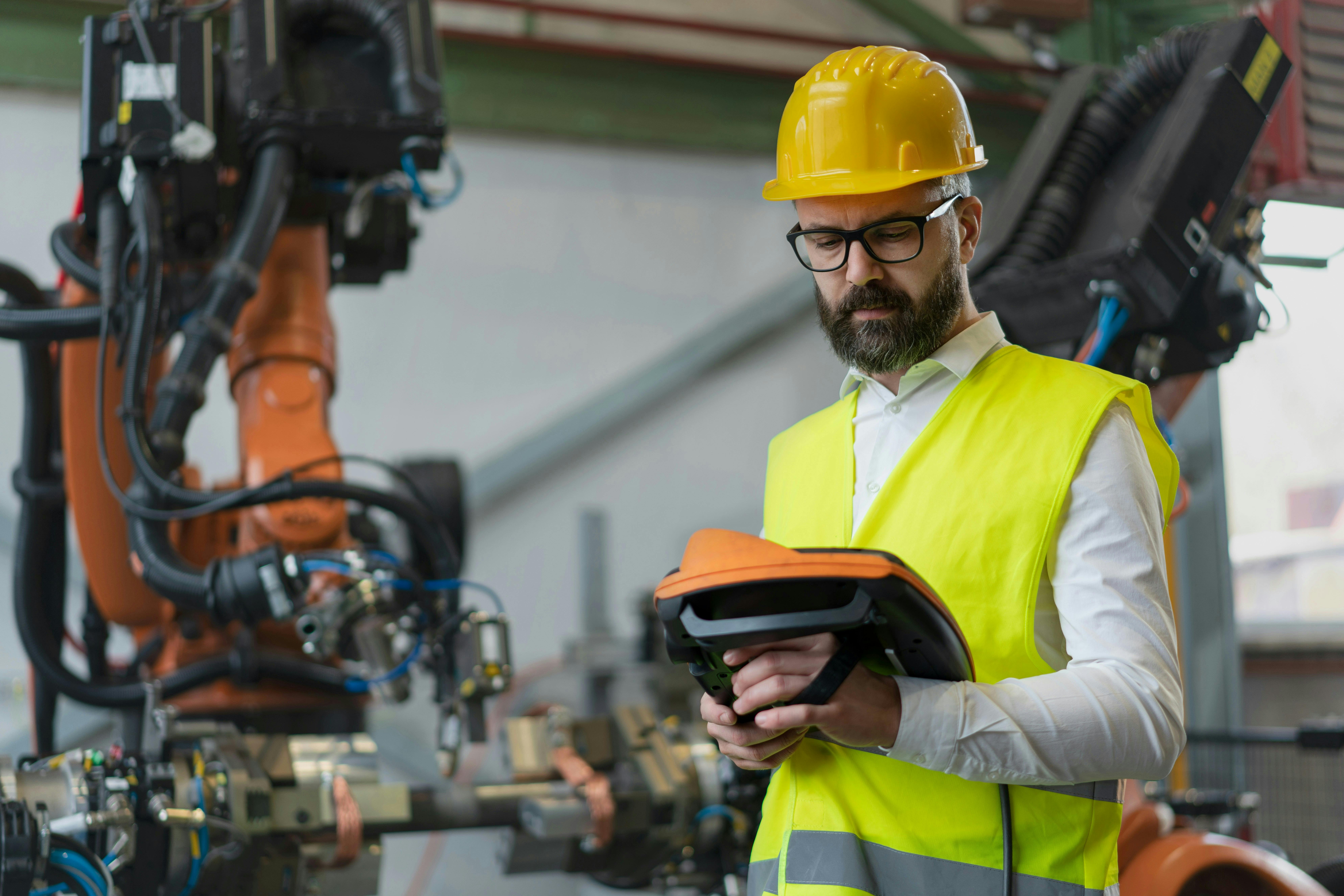 A reliability engineer using a predictive platform on an ipad
