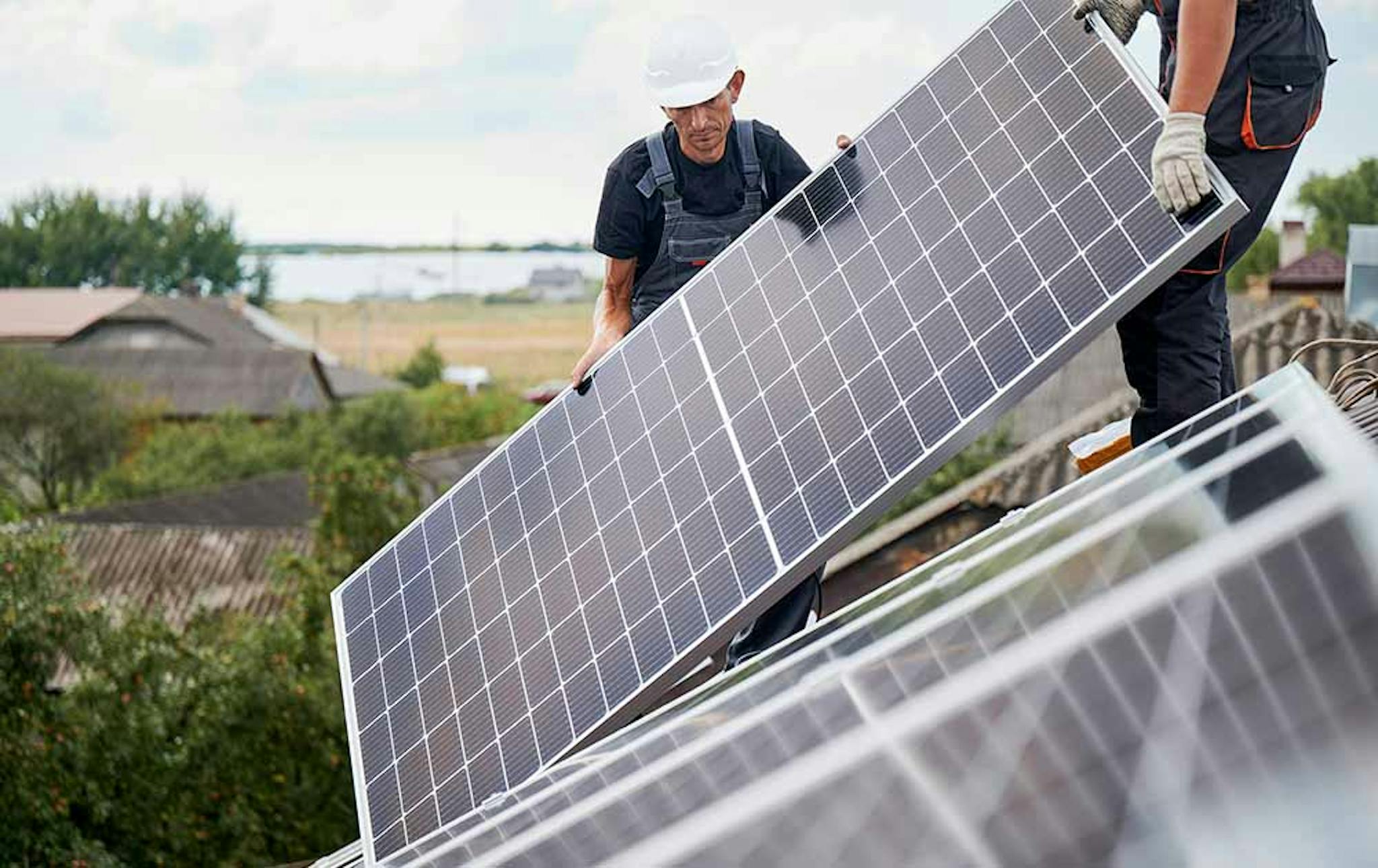 Photograph of workers installing solar panels