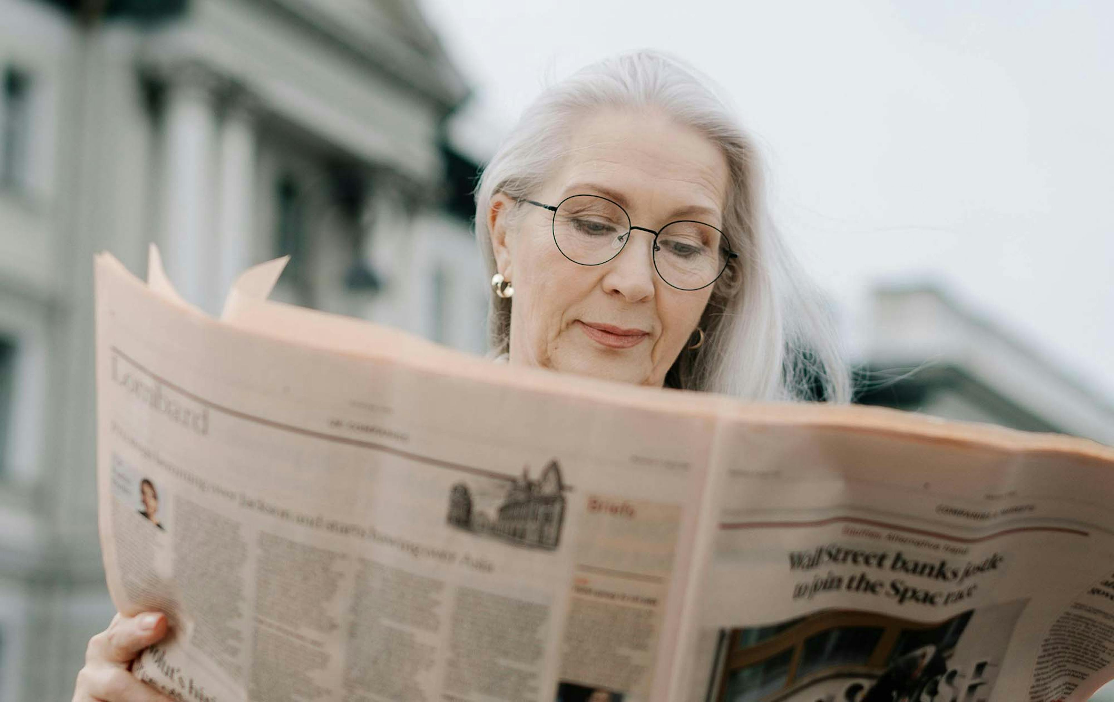 Photograph of a woman reading the Financial Times