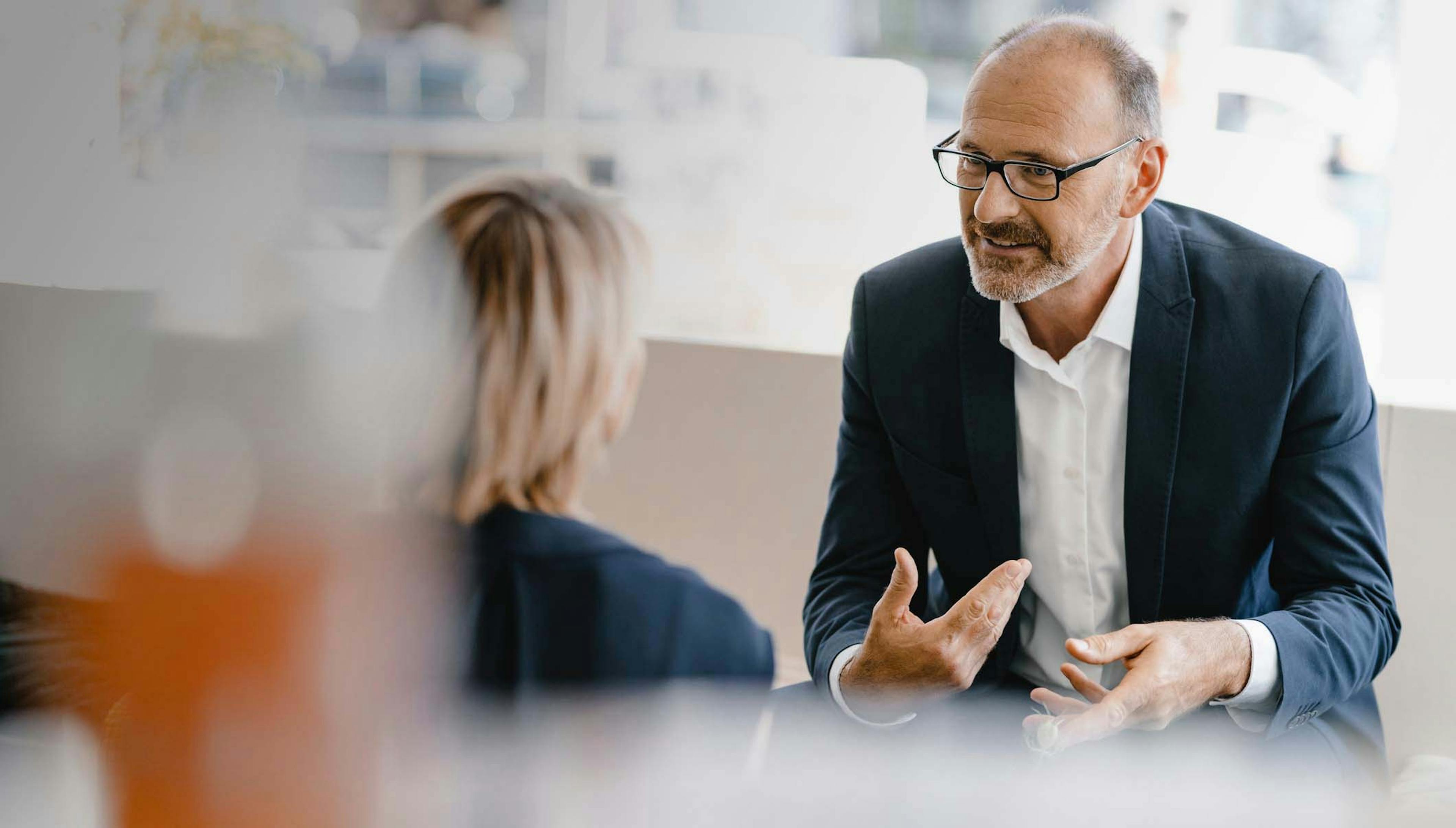 Photograph of an advisor speaking to a client