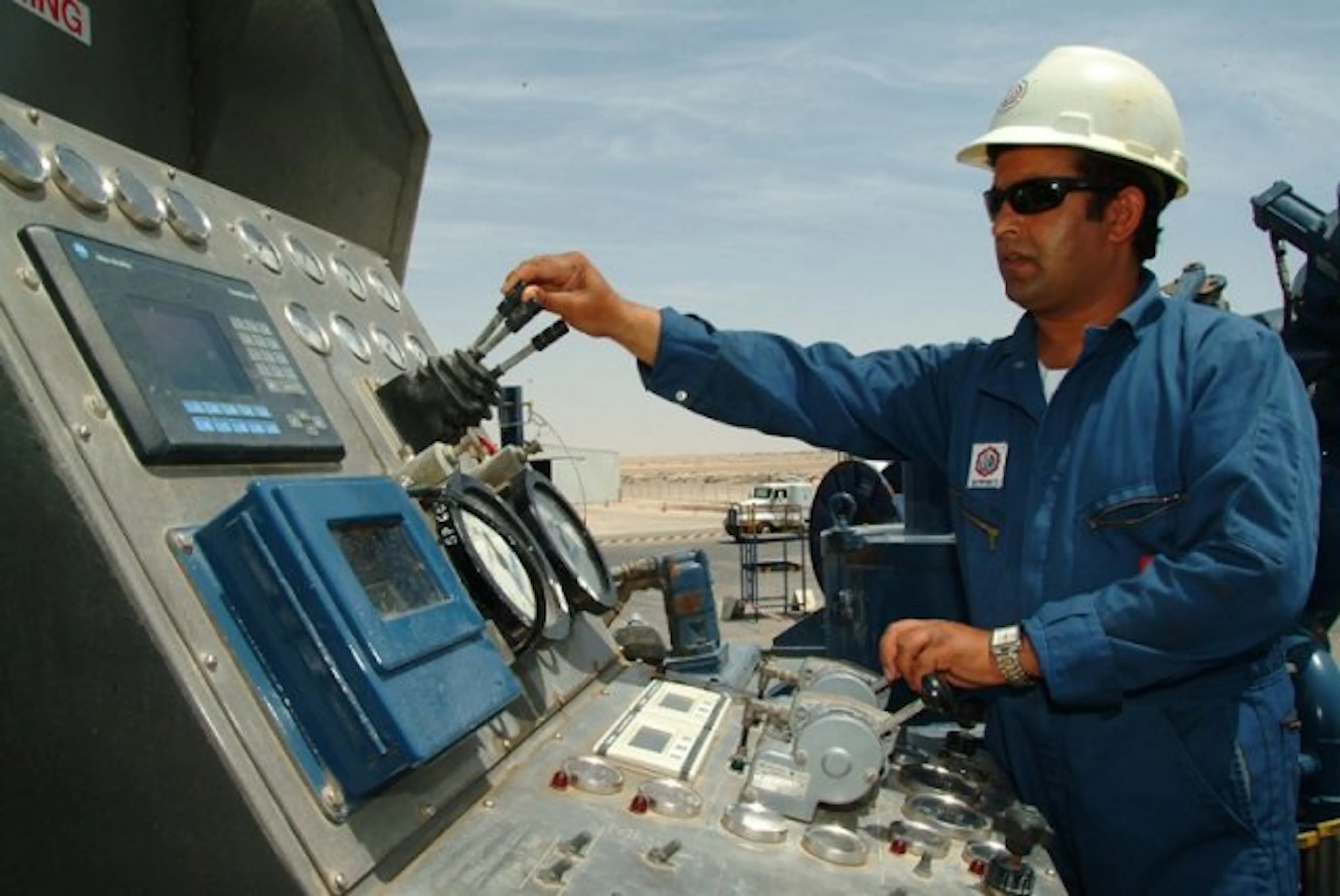 An NPS engineer operating oilfield control equipment
