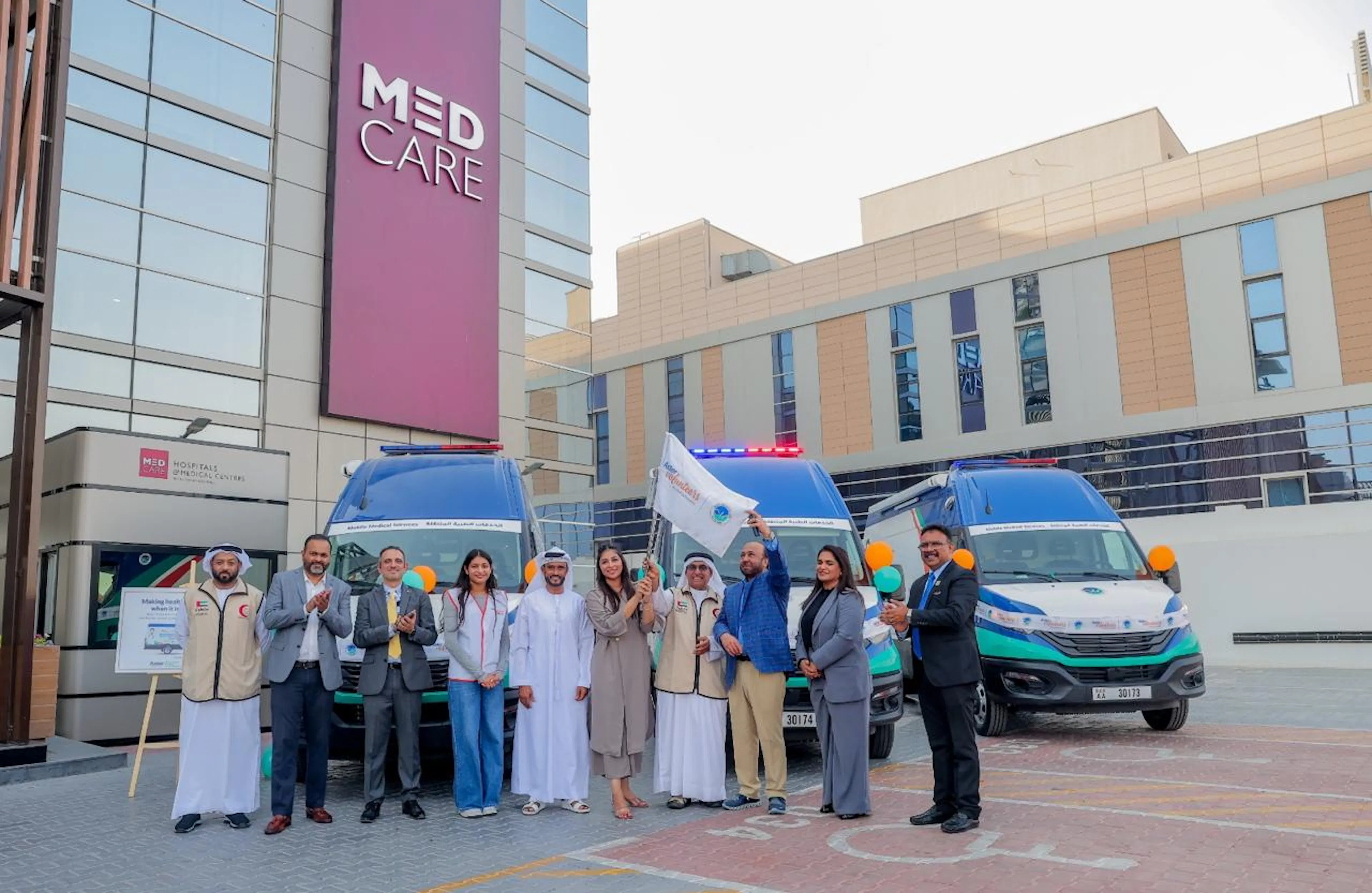 Aster Healthcare staff and volunteers at an ambulance fleet launch event