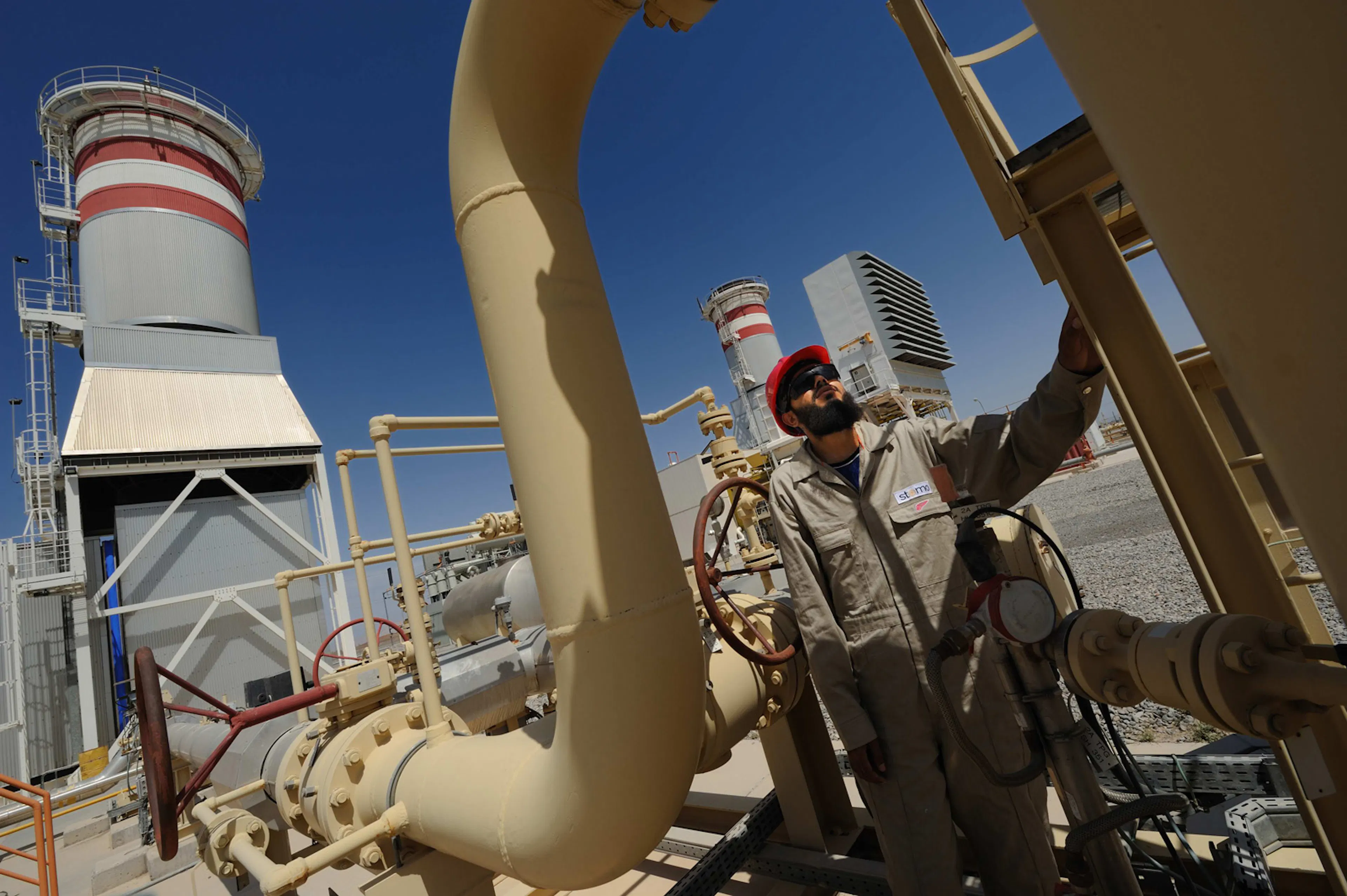 A United Power technician inspecting pipeline valves at the power plant