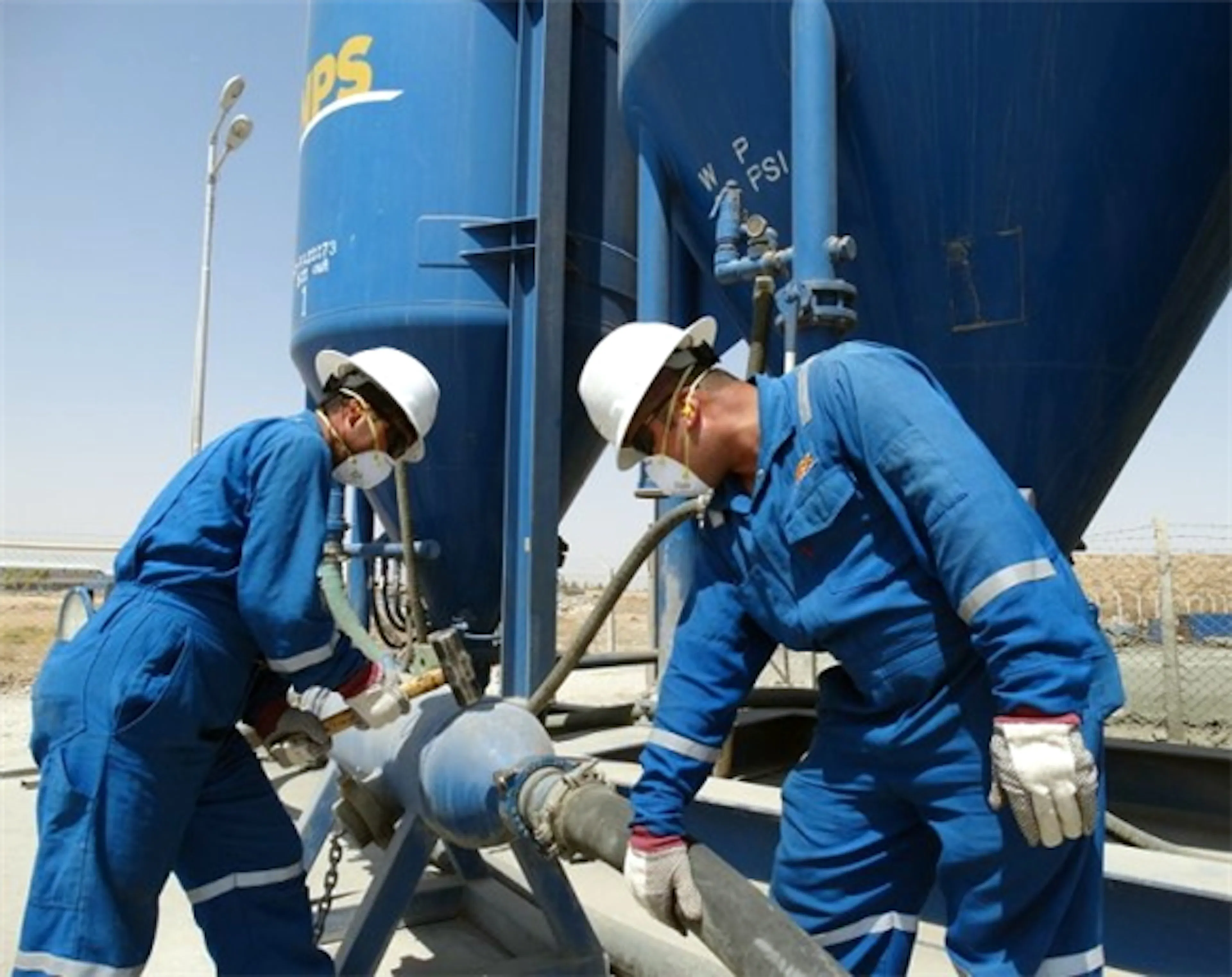 NPS technicians working on oilfield equipment