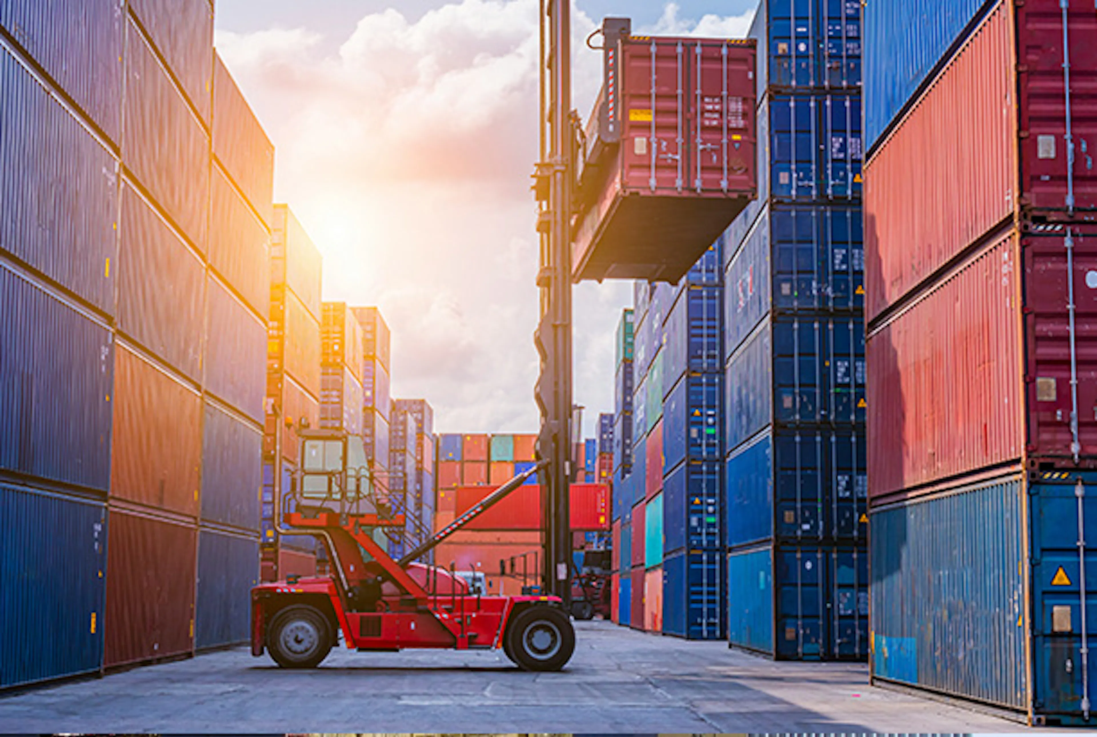 Forklift lifting a shipping container
