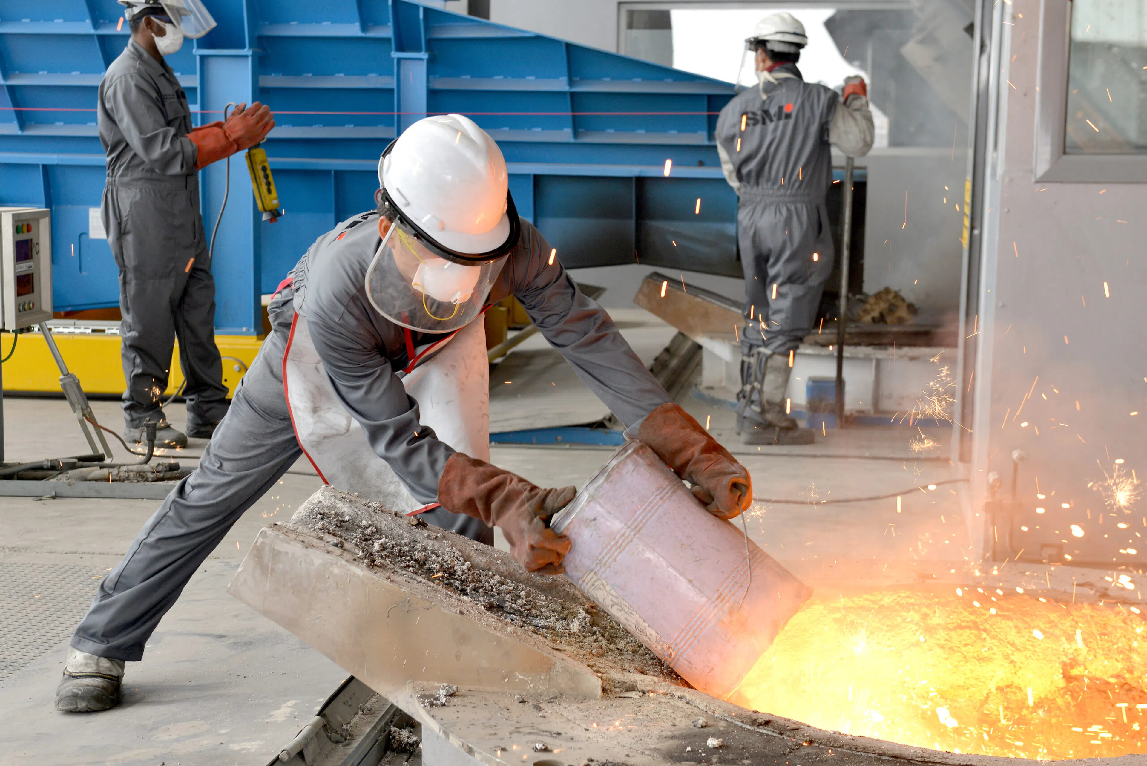 An industrial worker in protective uniform at a manufacturing facility