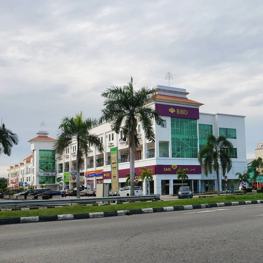 Exterior of the BIBD Serusop branch lined with palm trees