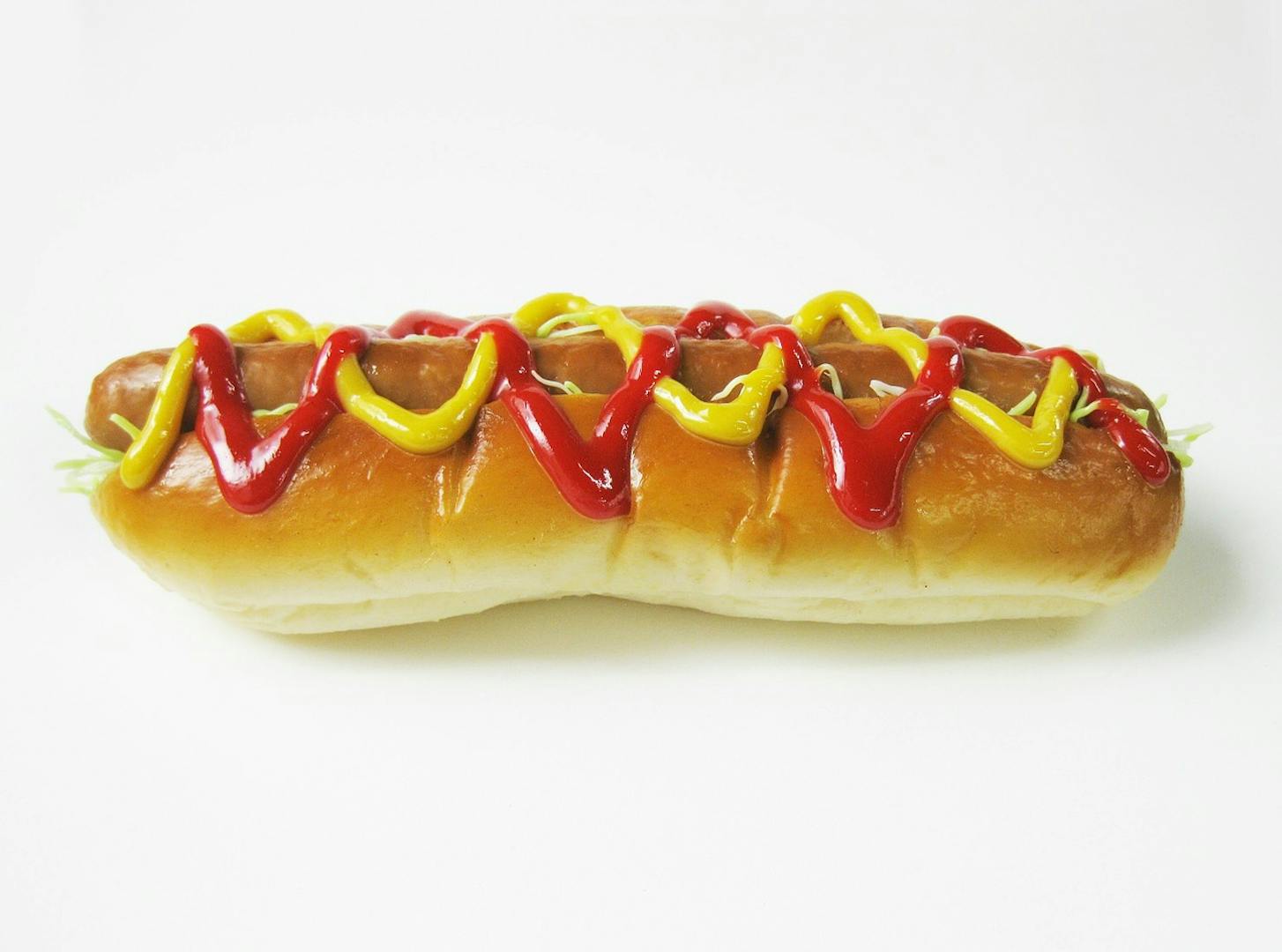 Hot dog with ketchup and mustard.