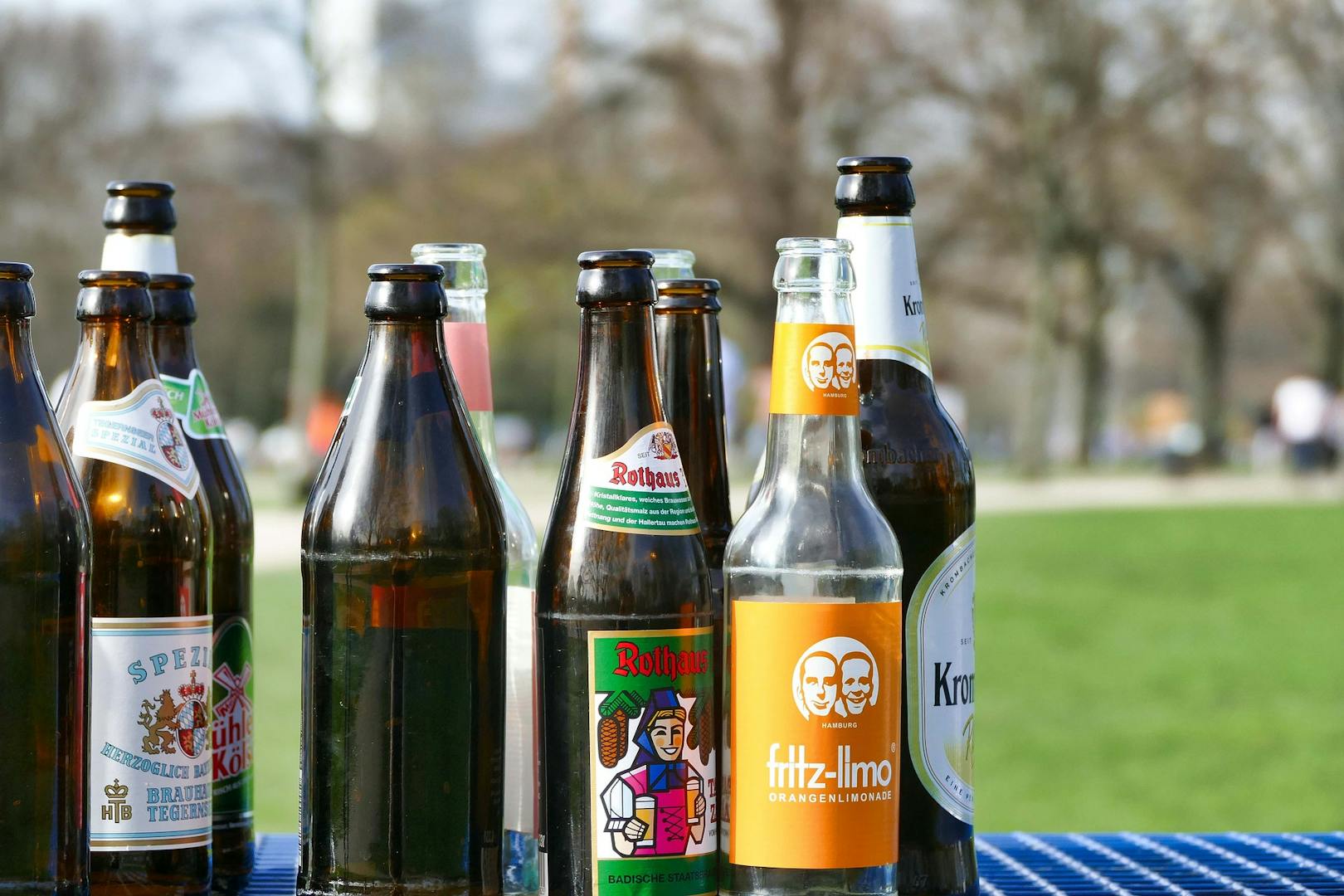 Random beer bottles arranged on a table.