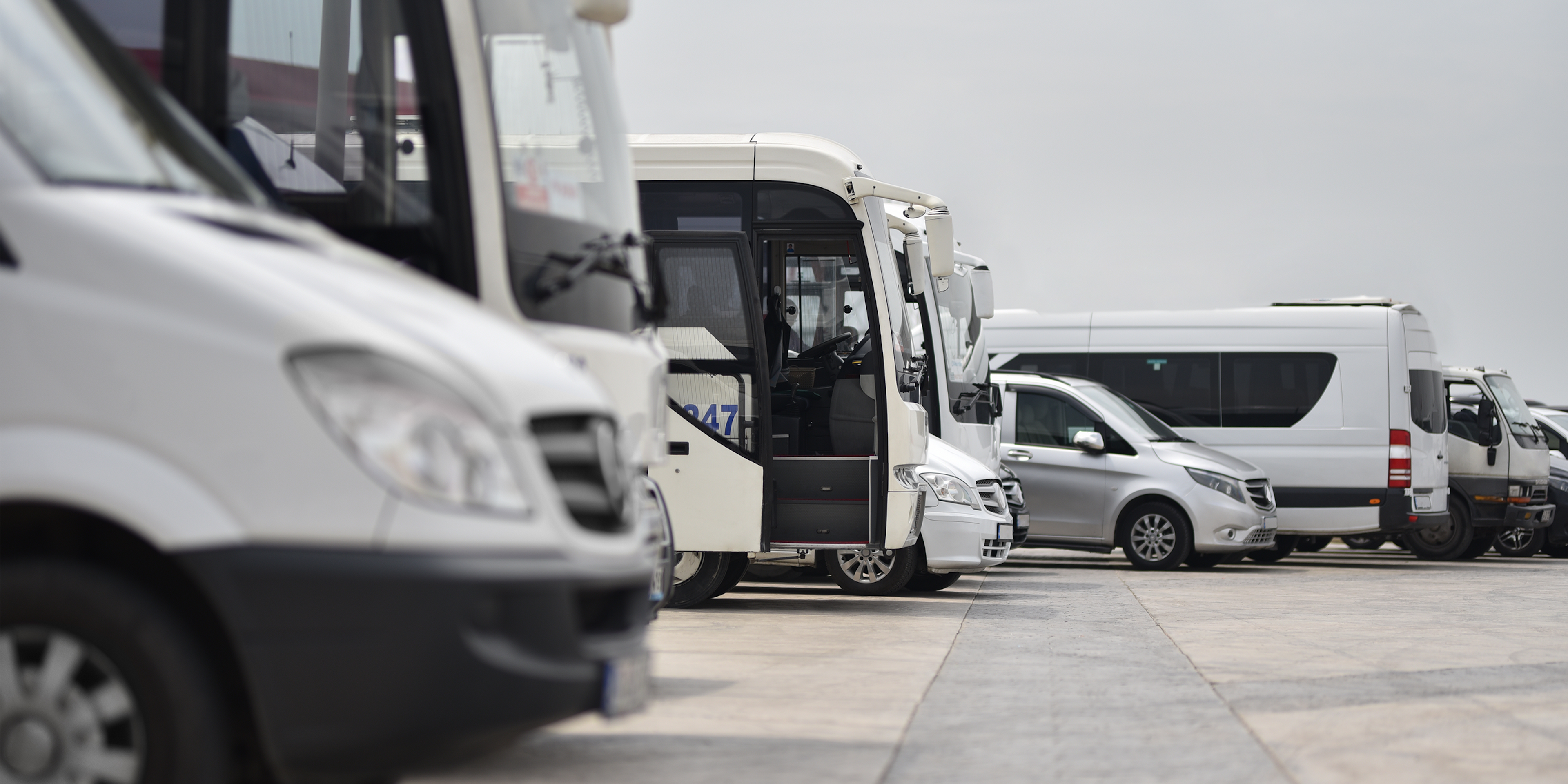 Fleet of white municipal vehicles.