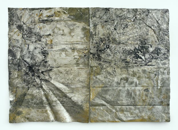 Two panels of paper that have been slightly crumpled, folded, and wrinkled, painted with mottled black, white, gold, and silver.