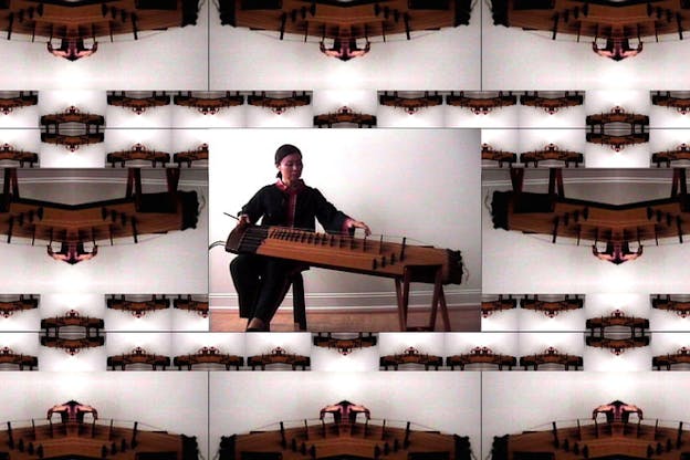 An array of images of Jin Hi Kim's komungo against a white background are distorted. A non-distorted image in the center shows Jin Hi Kim playing the komungo.