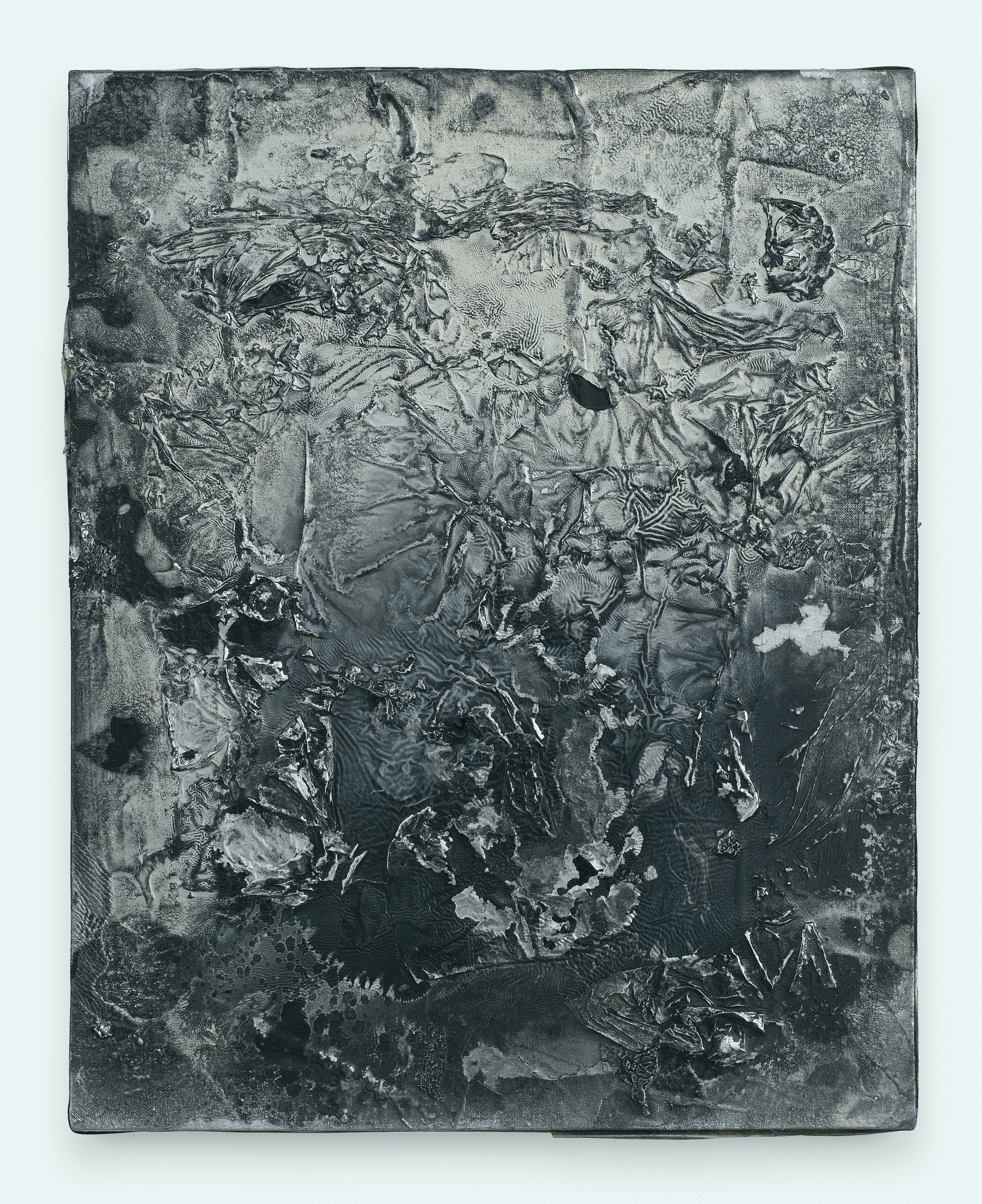 A linen canvas glistens with pools of shiny black and silver paint. Textured ridges and wrinkles cover the surface of the canvas.