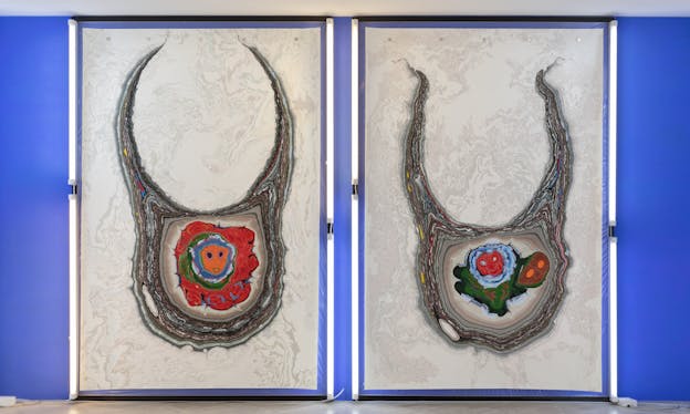 Two paintings side by side depict multilayered shapes that turn into horns at the top. In the center of each shape sit abstract blots of red, blue, green and orange that remind of faces.