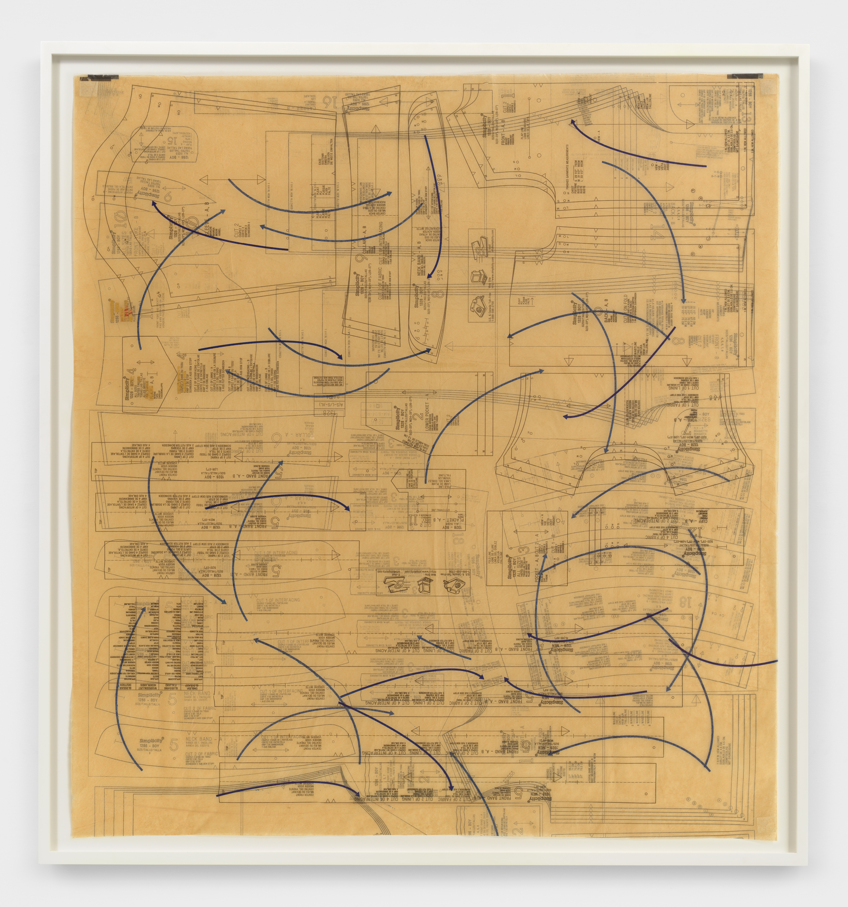 A square framed print of thin, curved navy blue arrows dispersed over tan, yellow layers of pattern paper with small black text.