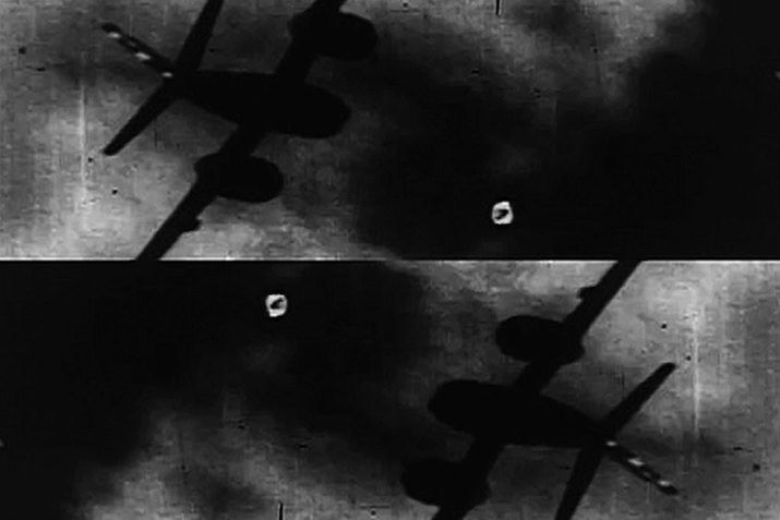 Two inversed black and white photographs of a fighter jet in a dark and cloudy sky.