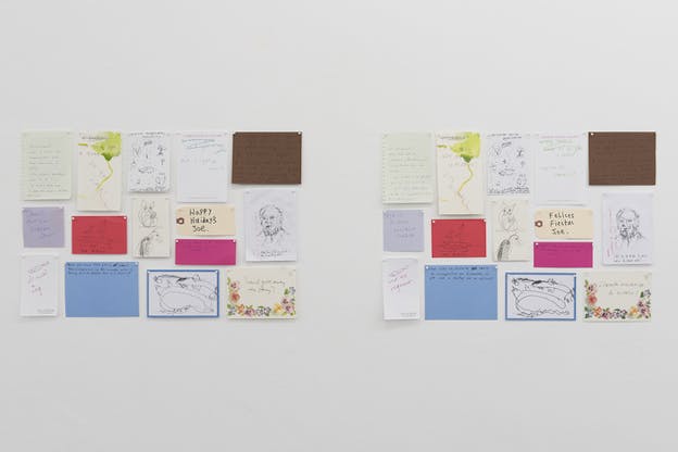 Two identical wall collages pinned side by side depicting notes of various colors and sizes with writings and drawings on them. A note on the left reads 