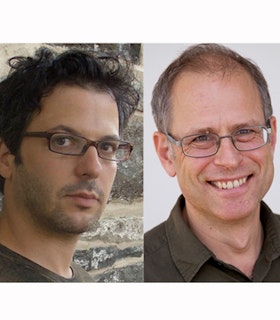 A split portrait with Shelley Eshkar on the left and Paul Kaiser on the right. Eshkar stands in front of a stone wall and turns to look directly at the camera. He has short curly dark brown hair and wears thin brown glasses and a brown t-shirt. Kaiser is in front of a white background. He has short gray hair and wears wire rimmed glasses and a collared brown shirt. He looks directly at the camera and smiles. 