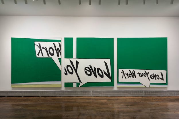 Three mostly green canvases are hung against an all-white wall. The canvas all the way on the left has a white speech bubble on it which says 