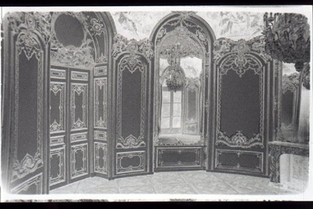 A black and white image of decorative wall panels forming a semi circle.