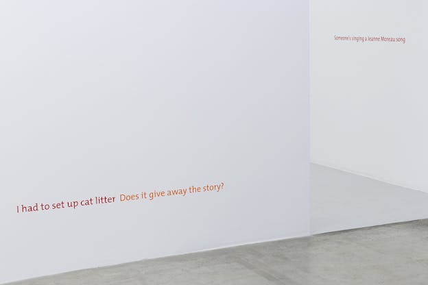 On the bottom of a white wall the phrase 