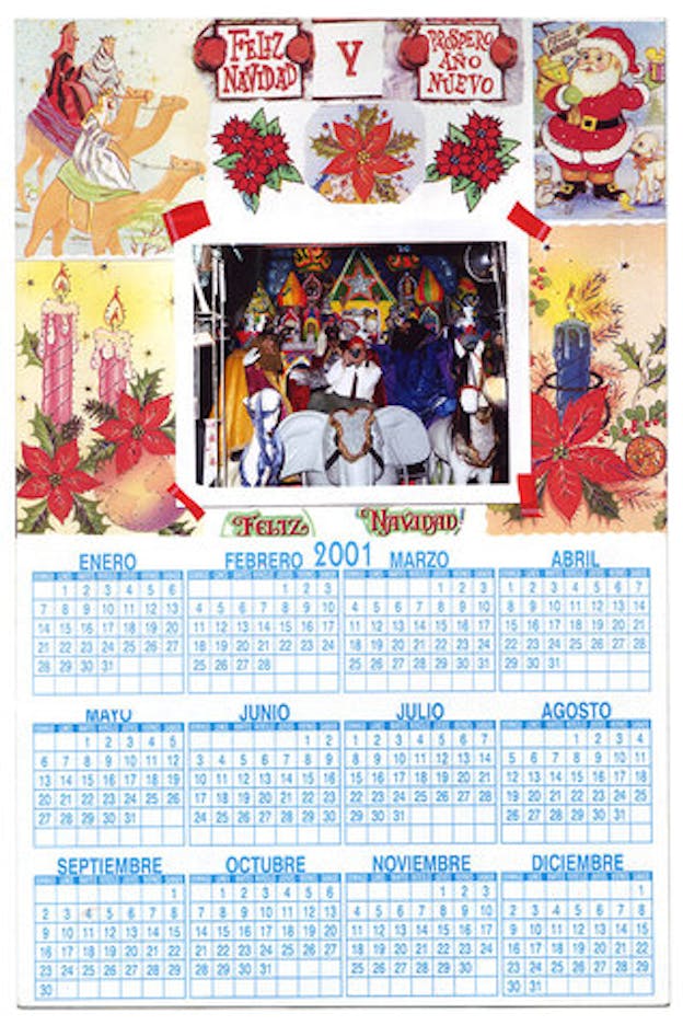 A calendar is shown. The bottom is filled with blue grids showing the months and days. The top half is a photo collage. Around the borders of this collage, there are drawn, cartoon images of candles, santa claus, and men on camels. The image on the top middle says 